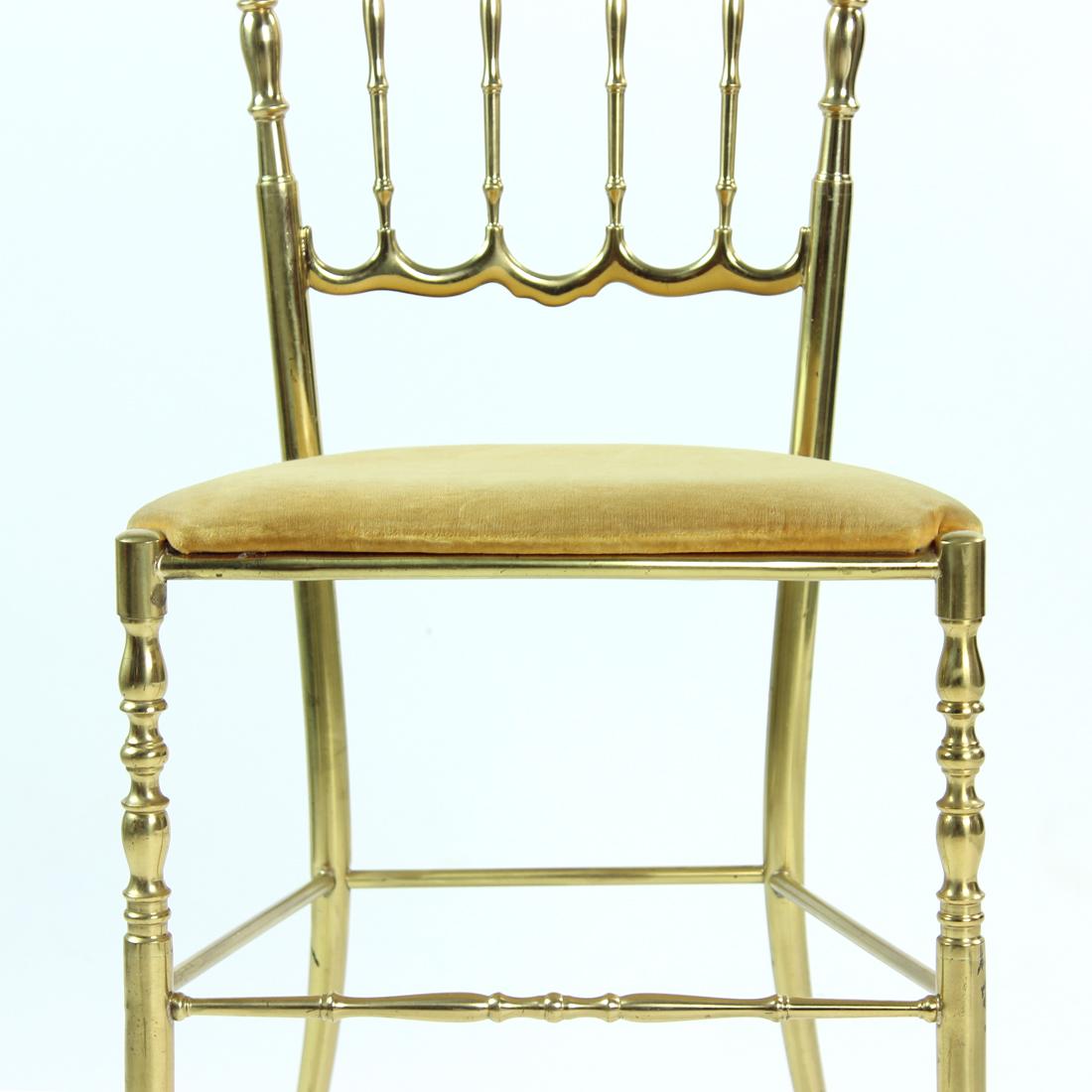 Beautiful mid-century Italian brass Chiavari spindle back chairs with padded seats upholstered in golden gobelin fabric. These polished brass chairs are designed by Giuseppe Gaetano Descalzi for Chiavari, named after the Italian city where they