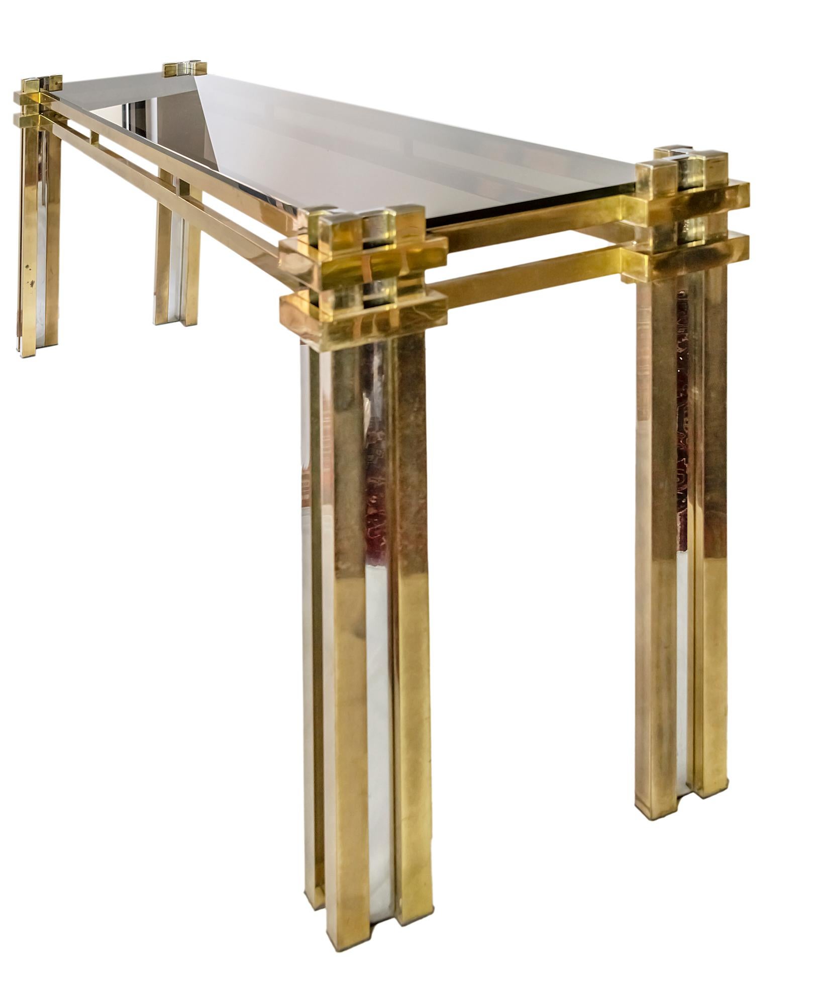 Italian console table by Romeo Rega from 1970's.
Brass and chrome base with tinted grey glass top.
It is heavy and solid.