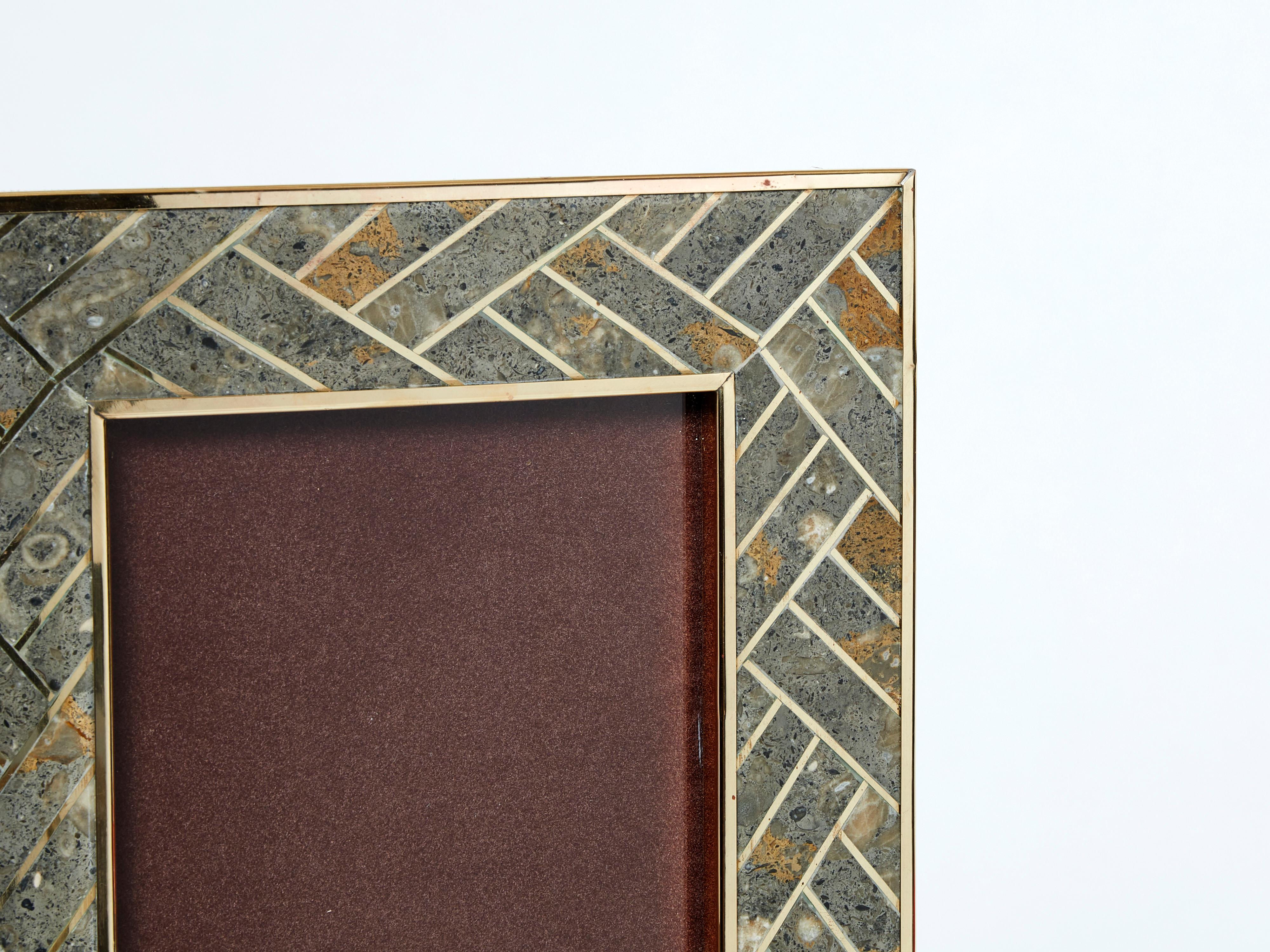 Beautiful Mid-Century picture frame made in Italy in the late 1970s. This brass frame is covered by fossil stone and brass marquetry, with brown velvet on the back. The mix of brass and stone is really nice, and typical of the 1970s Italian style. A