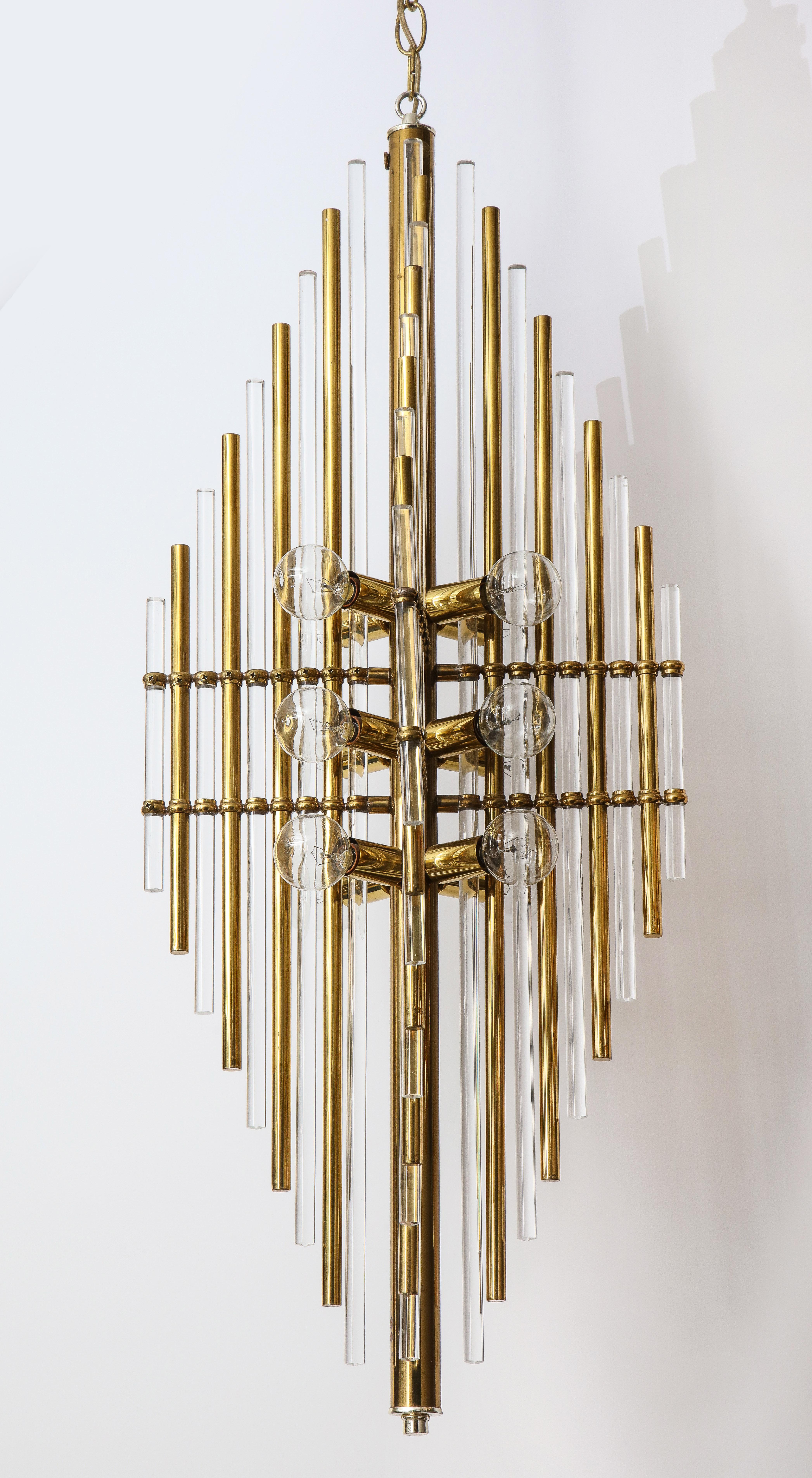 Midcentury 4 panel pendant, composed of alternating brass and Lucite dowels. Contains 12 sockets, using candelabra type bulb base. Comes with brass chain and canopy. 43