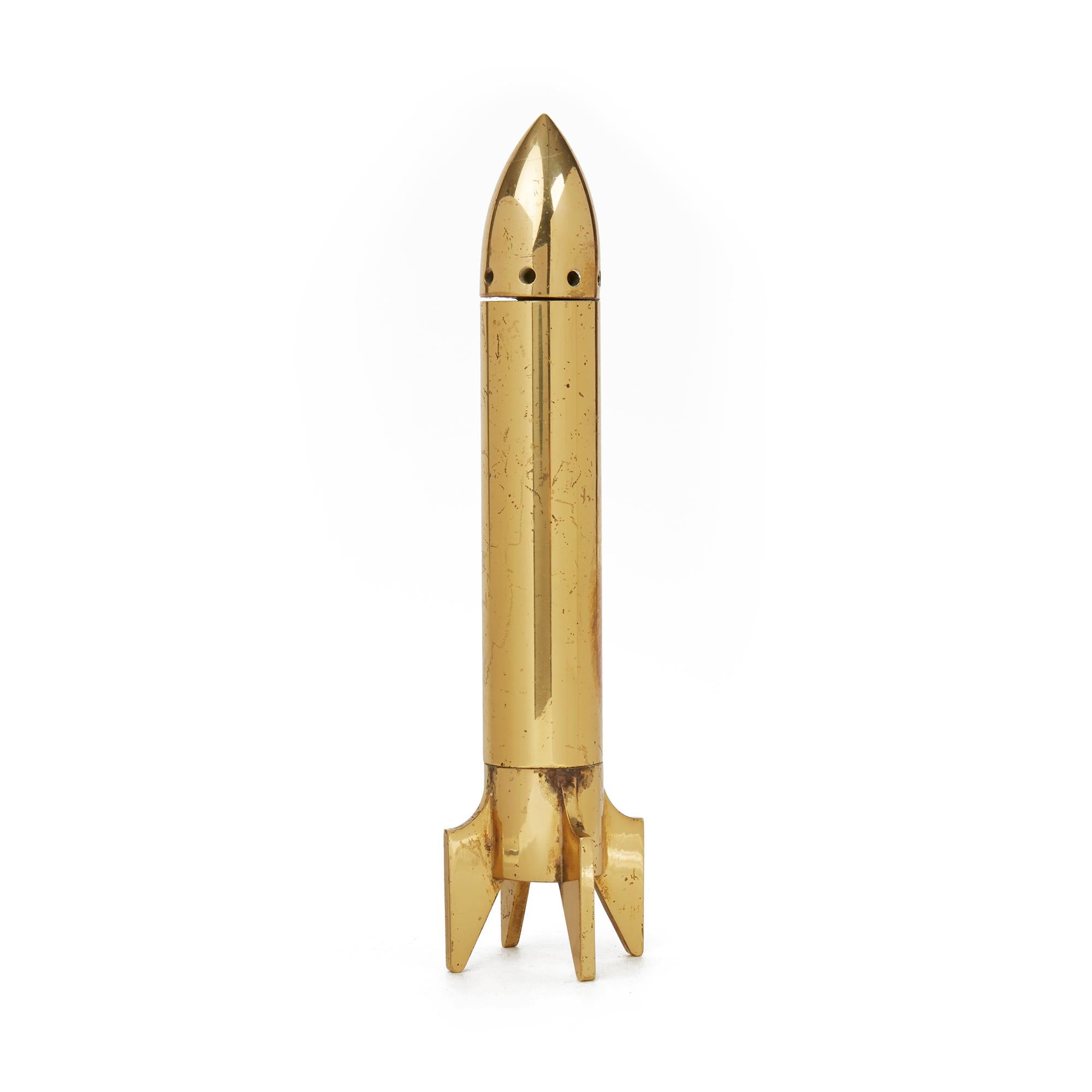 A very stylish Italian midcentury solid brass corkscrew and bottle opener housed in a rocket. The rocket stands upright on its four tail fins which also unscrew to reveal a corkscrew while the nose cone unscrews to reveal a bottle opener. The rocket