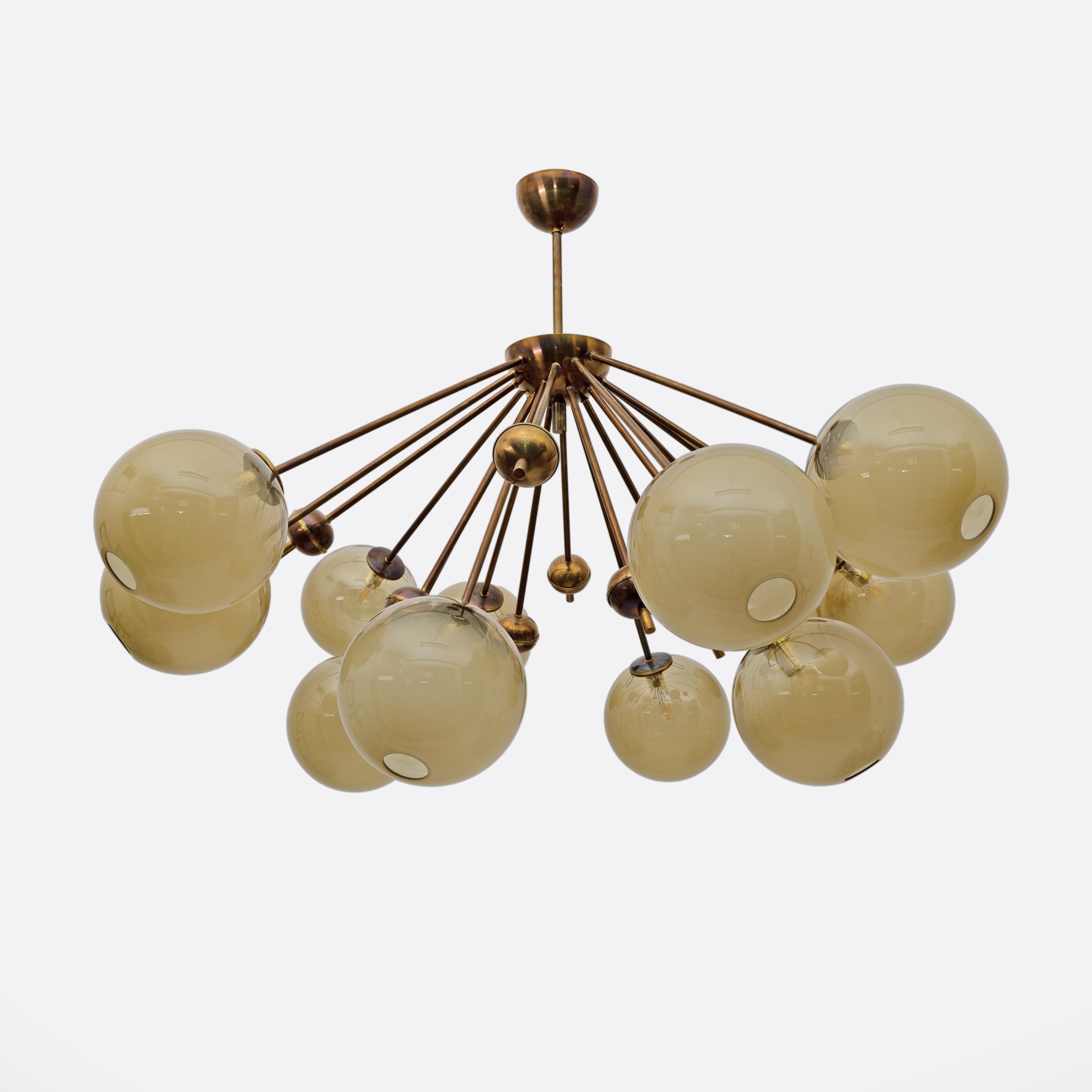 Extraordinary Mid-Century Style Sputnik chandelier in burnished brass and 12 Murano glass spheres.
Also available as a pair. The height of the brass rod can be customized.
11 lamp holders with E14 socket for Europe or E12 for the USA.
This fixture