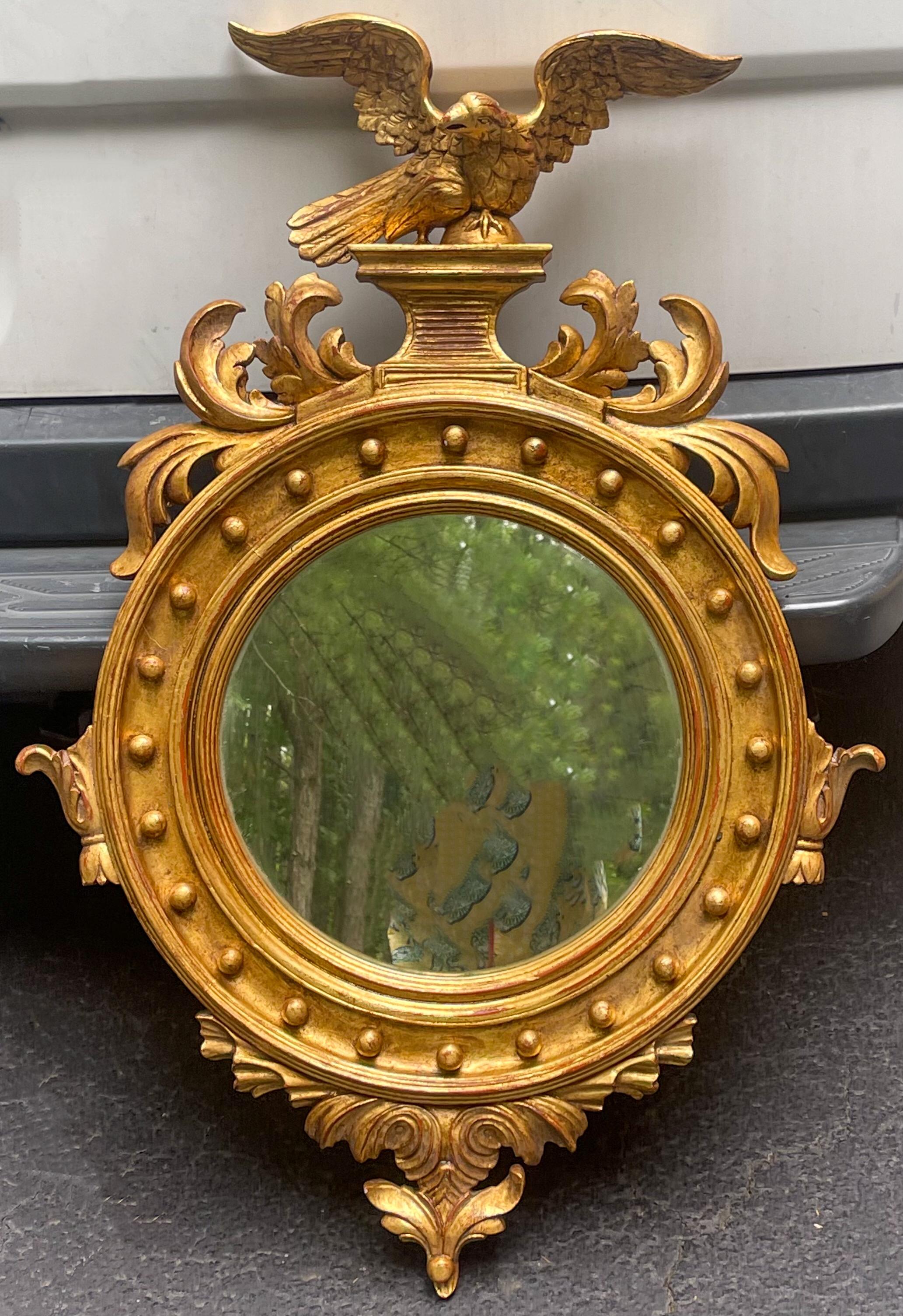This is a pair of carved giltwood eagle mirrors with Federal styling in very good condition. They are Italian and most likely date to the 60s. The pair are unmarked.