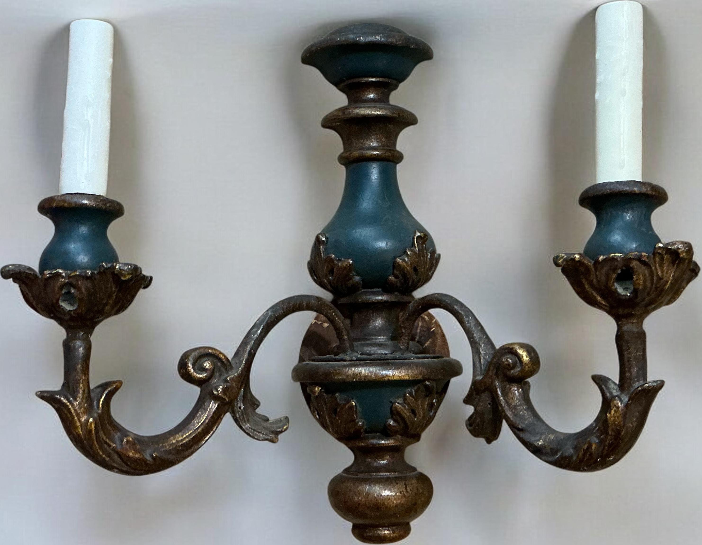 This is a pair of mid-century Italian carved giltwood sconces with original blue paint. They are both in working order and have some age appropriate wear to the wood. 