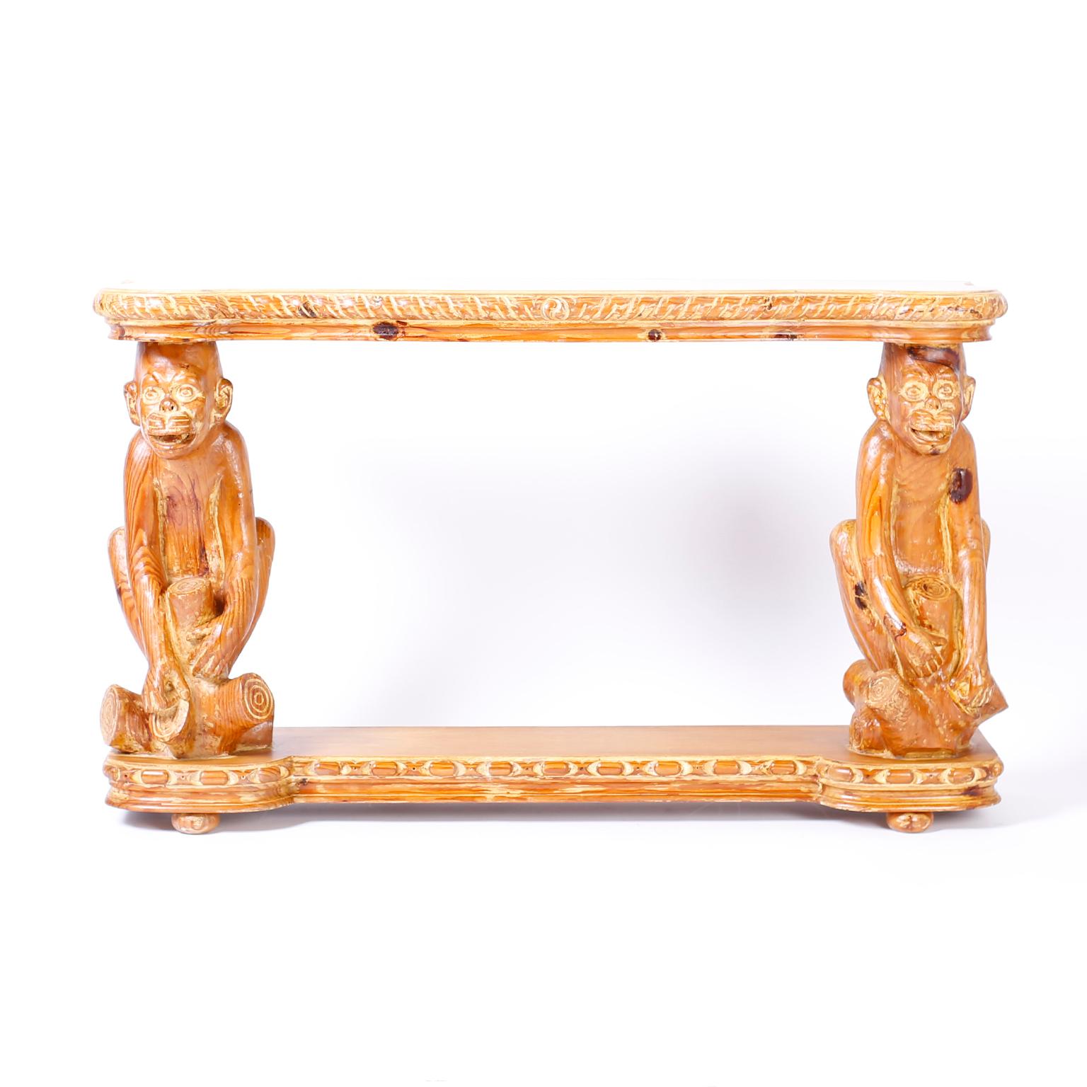 Whimsical carved pine console table with a desirable slim profile, scalloped top, carved monkey supports and a stylized base with bun feet.