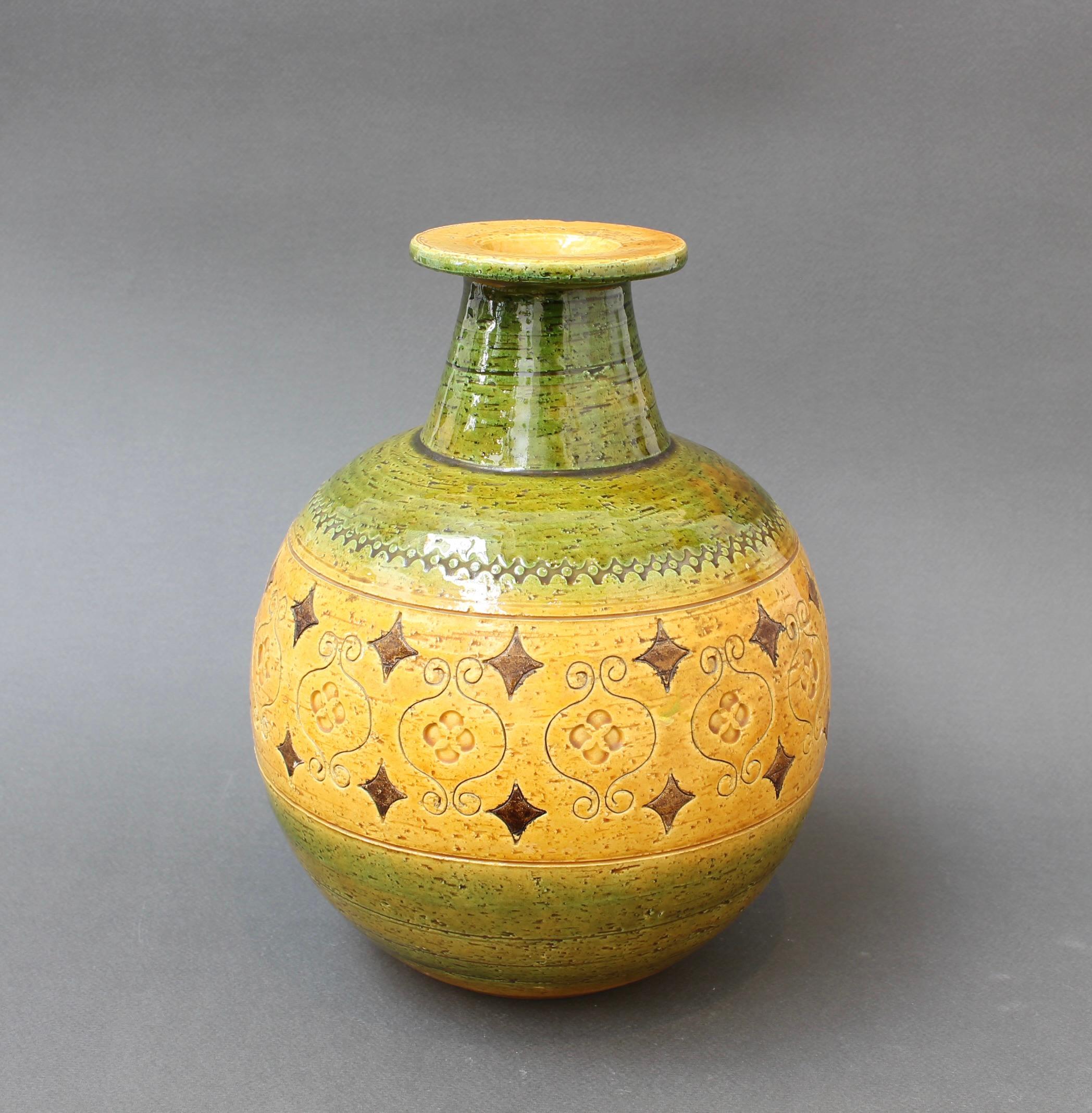 Mid-Century Italian ceramic vase by Aldo Londi for Bitossi (circa 1960s). Part of the 'Arabesque' range designed by Aldo Londi which was produced in the 1960s, it presents a glazed central yellow band with green at the neck and base. These pieces