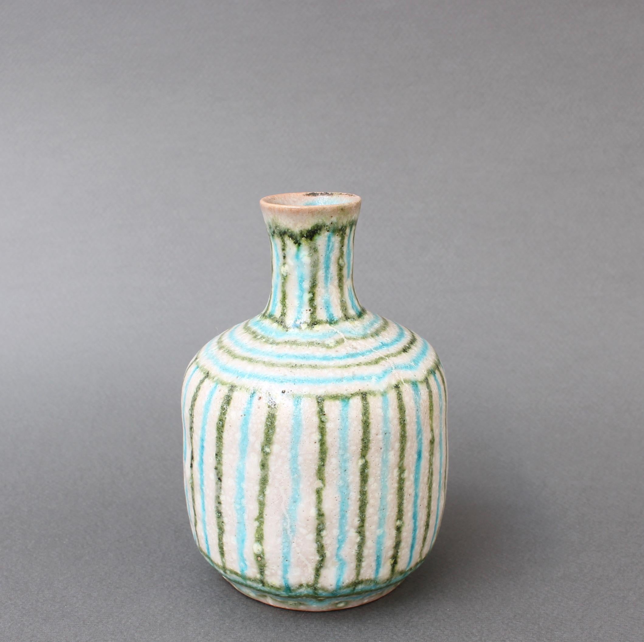 Small midcentury decorative ceramic vase by Guido Gambone, (circa 1950s). Another work of art by the formidable Guido Gambone, this diminutive pieces Form is reminiscent of ancient vessels. The vertical linear pattern in green and baby blue is