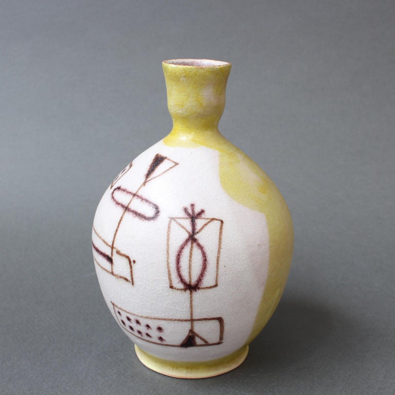 Midcentury decorative ceramic single-flower vase by Guido Gambone, (circa 1950s). Another work of art by the formidable Guido Gambone, this diminutive piece's form is reminiscent of ancient vessels. The naive abstract sketches Stand out over an