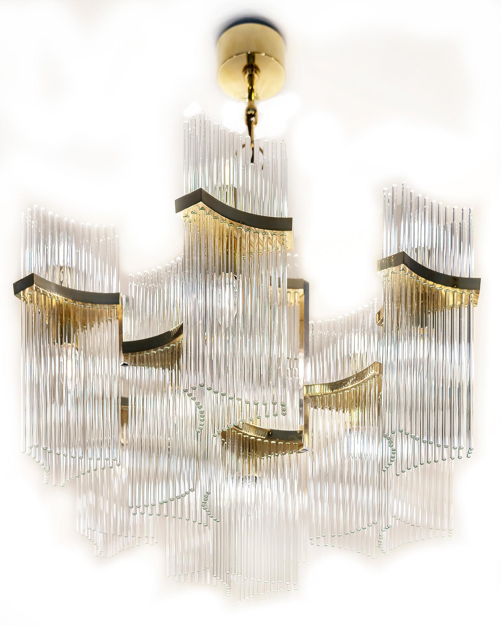 Italian mid-century Sciolari chandelier is made of polished brass and clear glass stick rods in the holders. 
This chandelier includes E14 bulbs: 11 pcs. lighting down and 9 pcs. lighting up.
It is in a very good original vintage condition.

