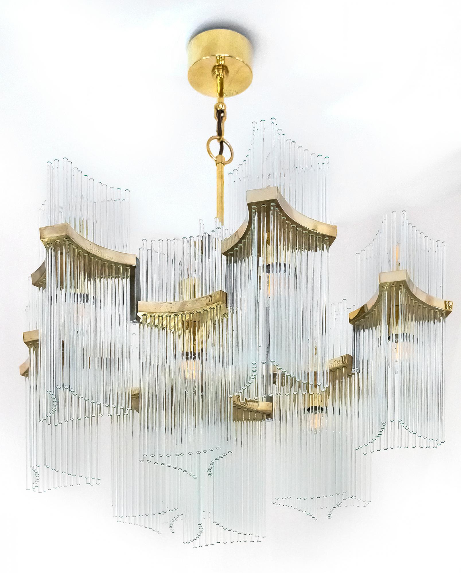 Italian mid-century Sciolari chandelier is made of polished brass and clear glass stick rods in the holders. 
This chandelier includes E14 bulbs: 11 pcs. lighting down and 9 pcs. lighting up.
It is in a very good original vintage condition.

