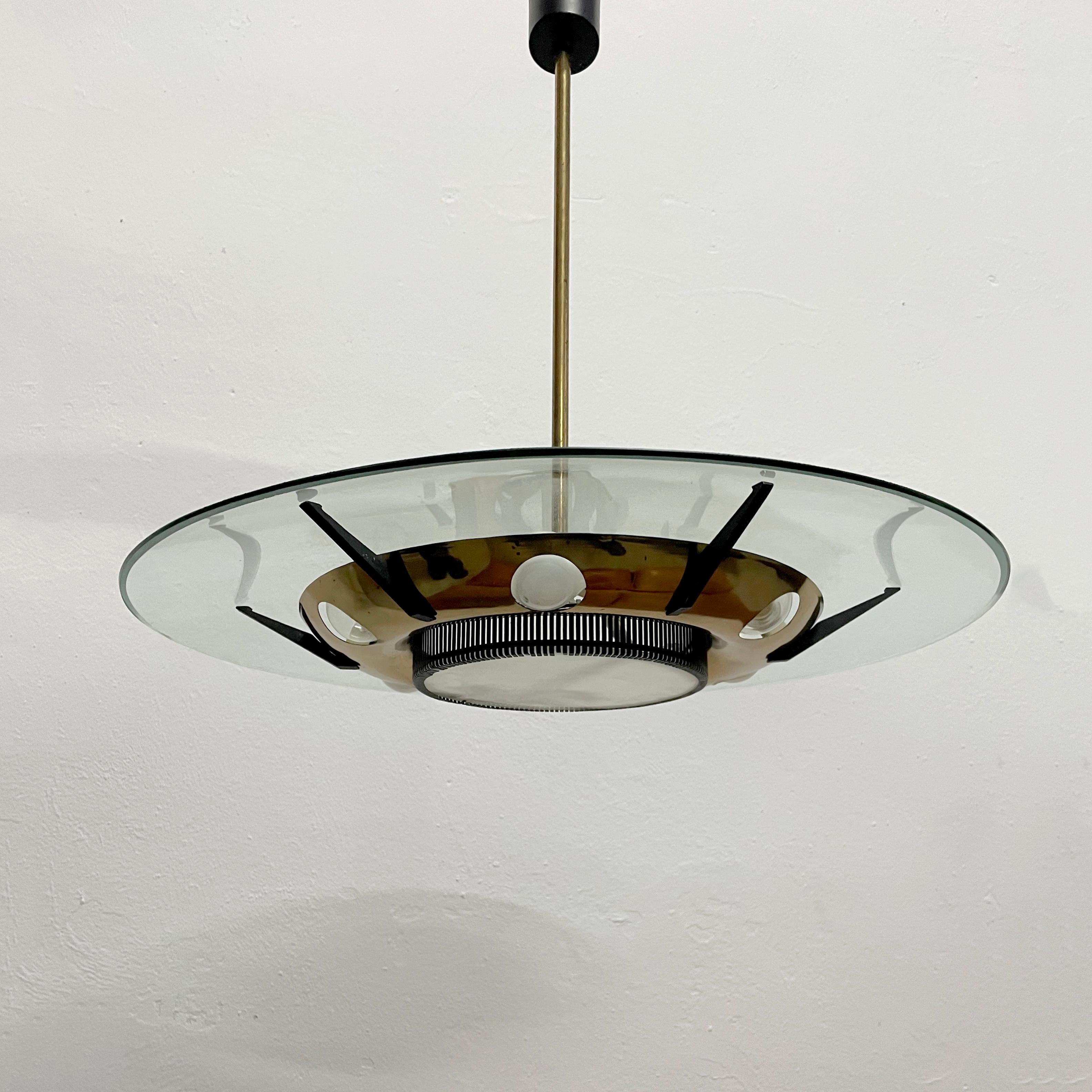 Offered for sale is a rare 1950s chandelier by Stilnovo in very good original condition.

This stunning chandelier is made of glass, brass, and black lacquered metal. The brass petal that connects the light to the ceiling has two parts and by