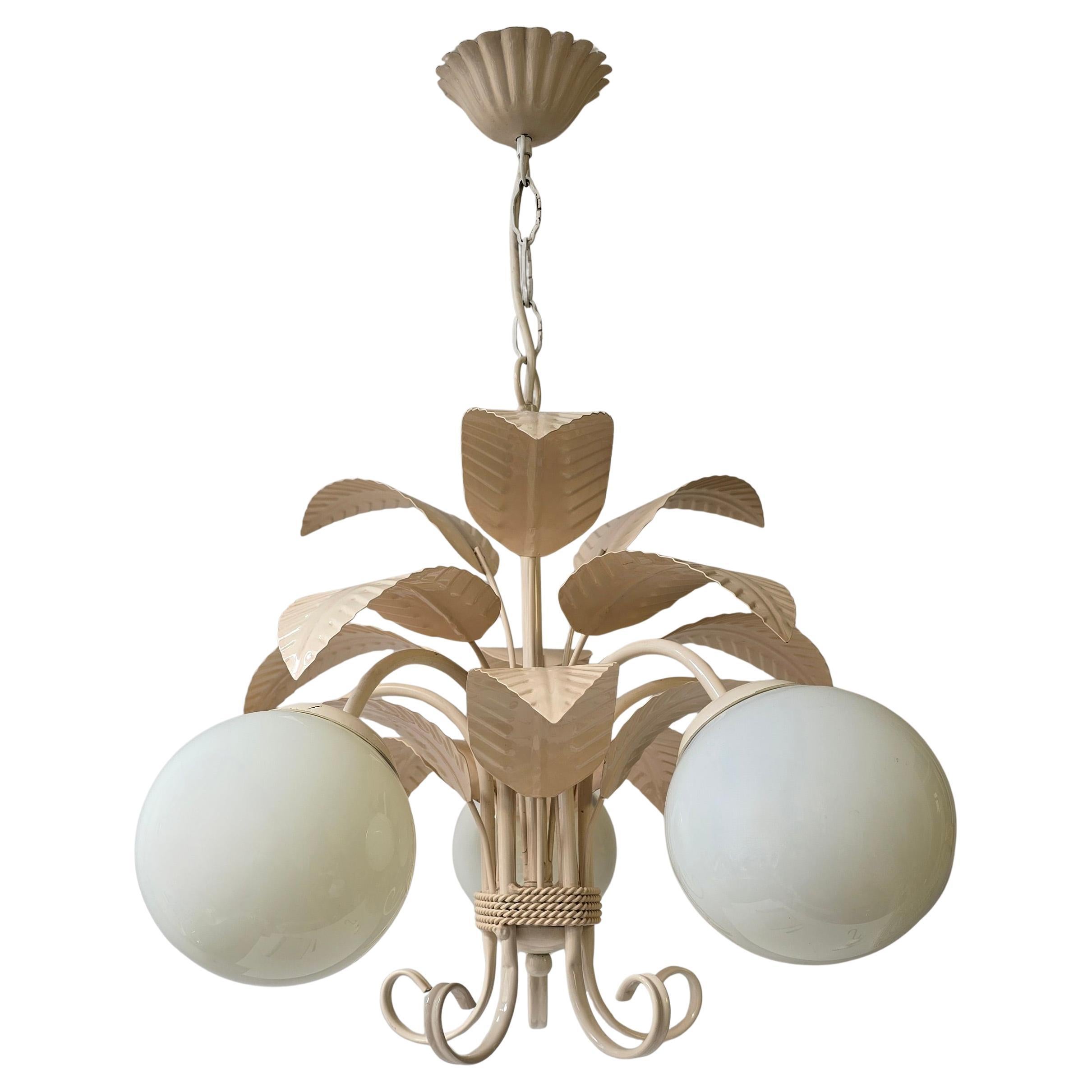 Mid-Century Italian Chandelier in Cream White with Opaline Glass

Italian mid-century chandelier from the 1960s-70s, made of metal and painted in cream white. The design features graceful metal leaves and five Opaline glass balls, which create a