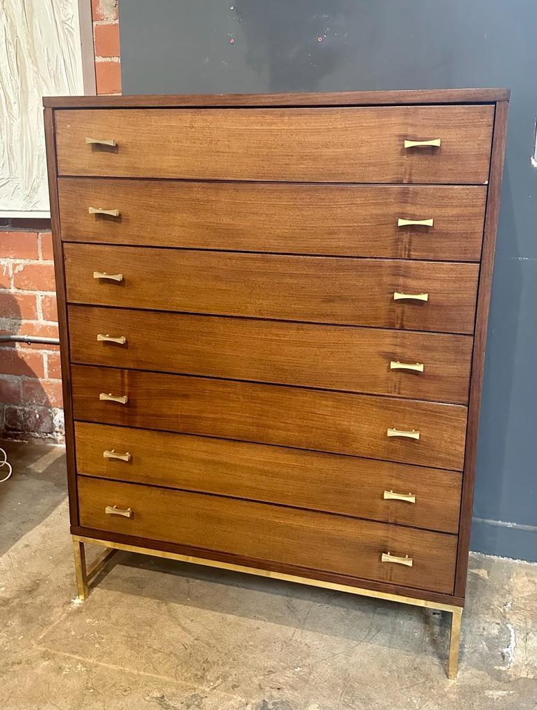 A midcentury Italian chest of drawers with a brass base and brass handles is a stylish and functional furniture piece that embodies the design aesthetics of the mid-20th century. It features a sleek and rectangular shape with clean lines, reflecting
