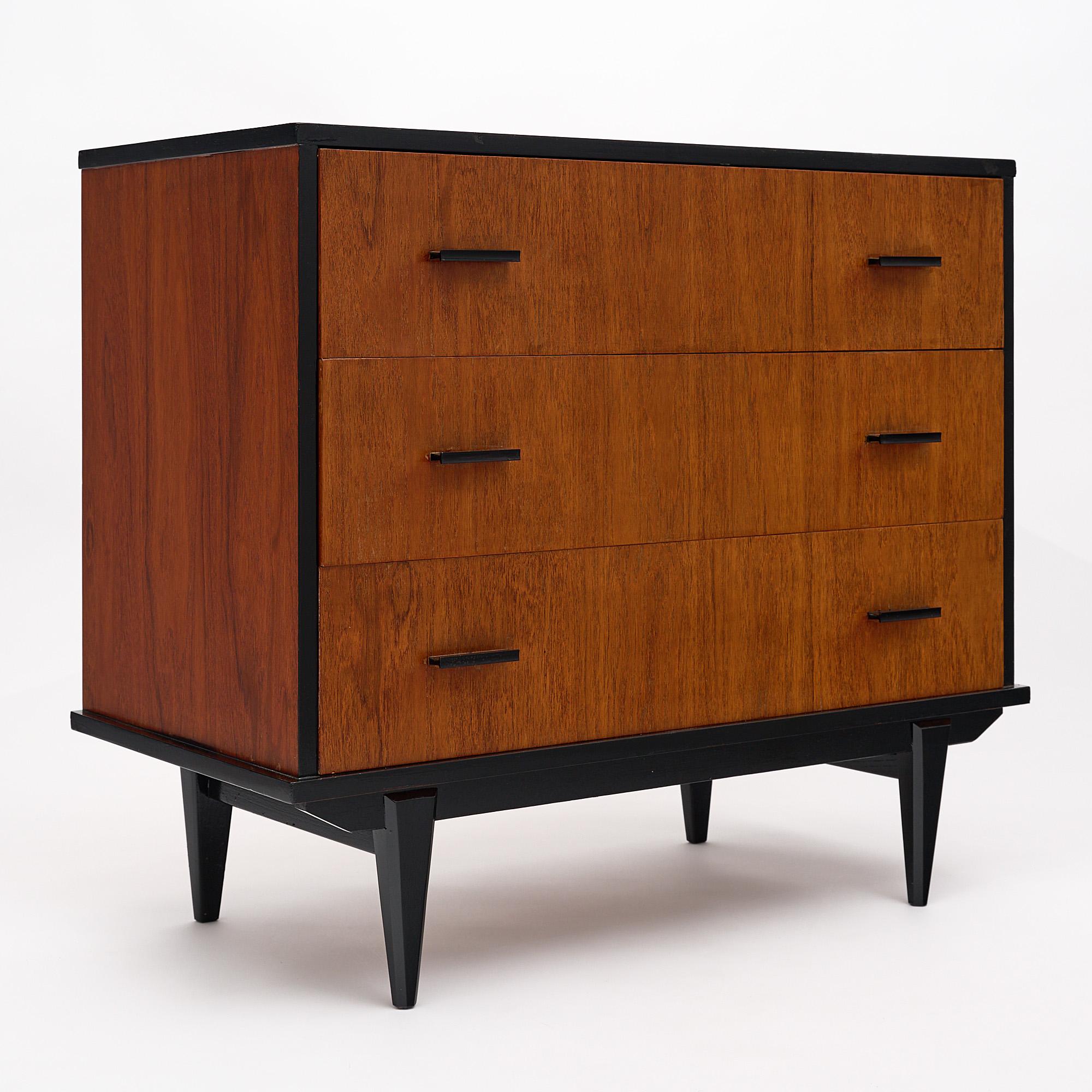 Chest, Italian, Mid-Century Modern made of teak with an ebonized trim and top. There are four tapered legs and three drawers.