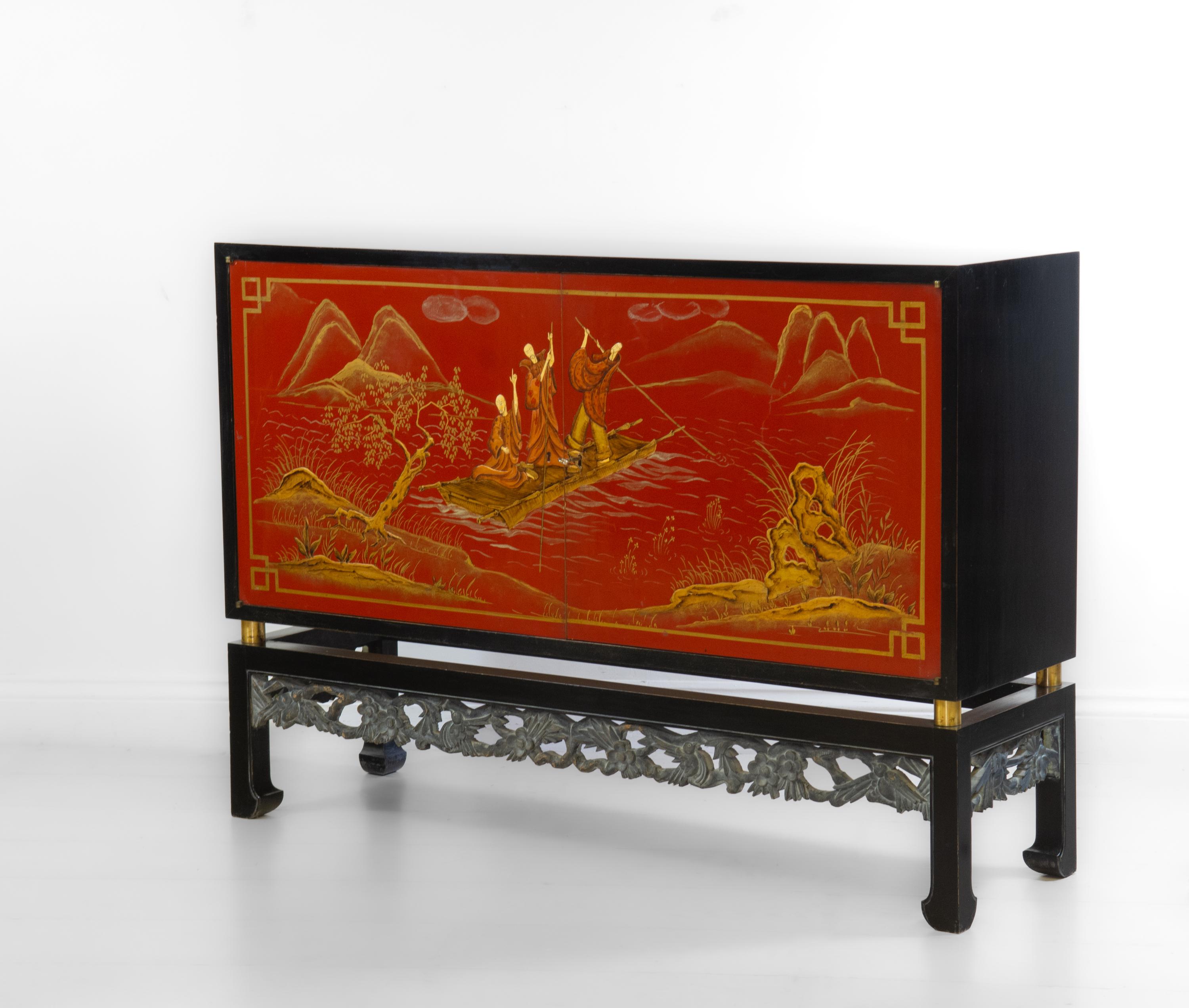 Mid Century Italian chinoiserie lacquered and ebonised sideboard. Circa 1950.

The sideboard is of good proportions and shows superb chinoiserie red-lacquered and gilt embossed doors depicting three men on a raft, with landscaped fore and
