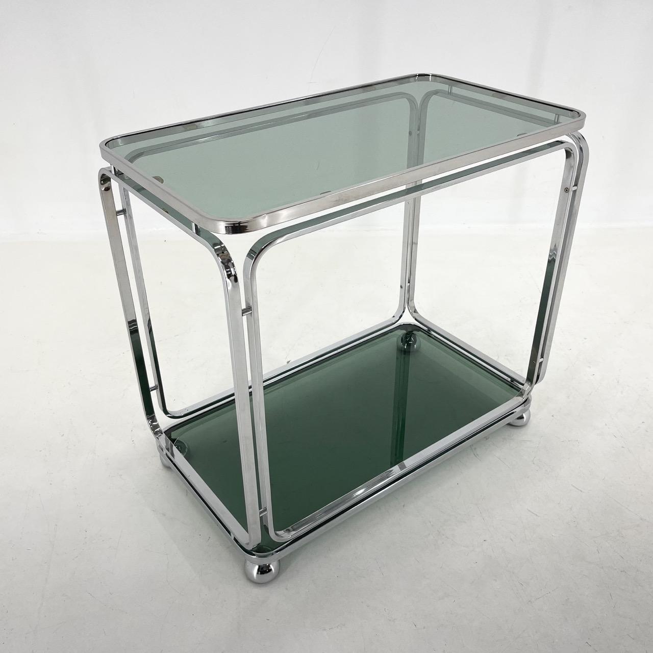 Stunning chromed serving cart with two smokey glass from Italy. In very nice vintage condition.