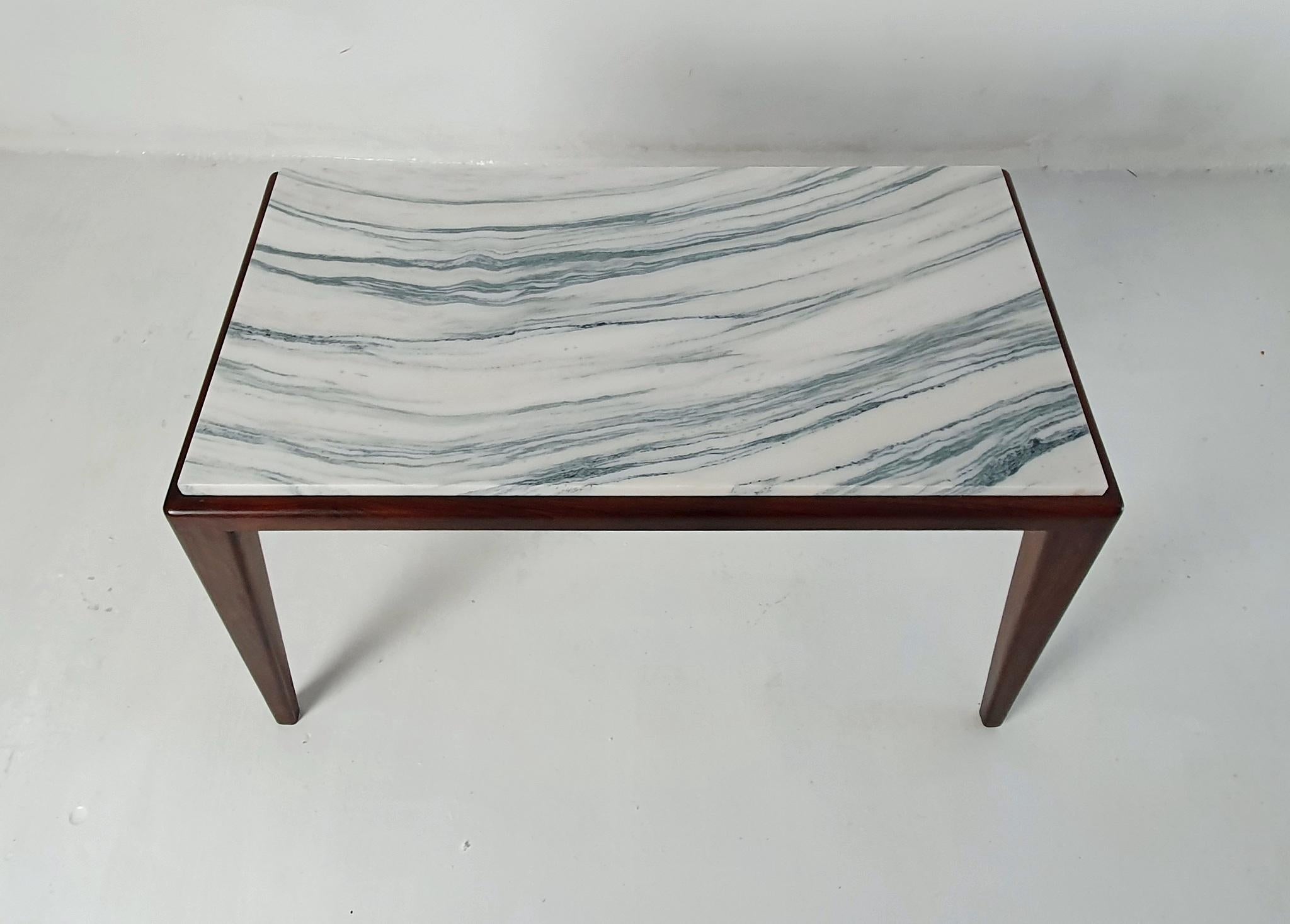 
Indulge in the timeless beauty of this super elegant coffee table, produced in Italy during the 1950s in the manner of Gio Ponti. The piece boasts exceptional craftsmanship, evident in its exquisite design and the precision of the walnut base