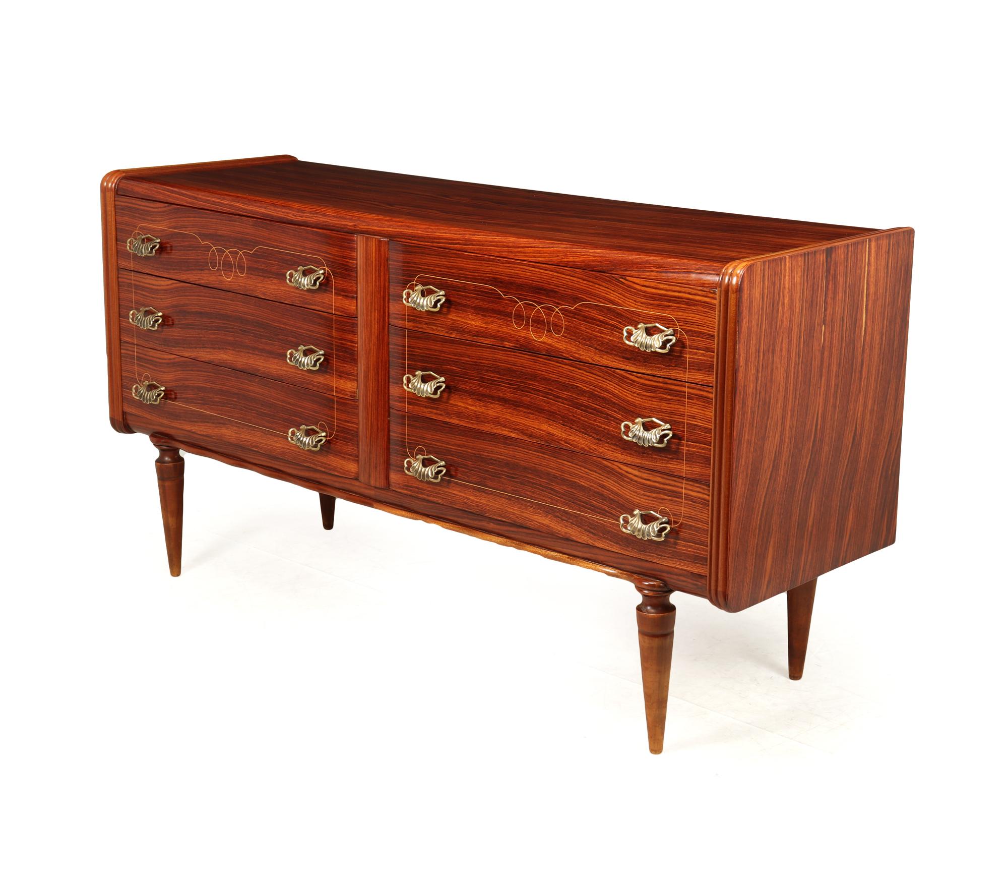 A Mid century six drawer chest produced by Dassi in Italy in the 1950’s, the chest stands very elegantly on four tapered turned legs and has two sets of three drawers with quality blonde linework inlay around the handles, these are very ornate and