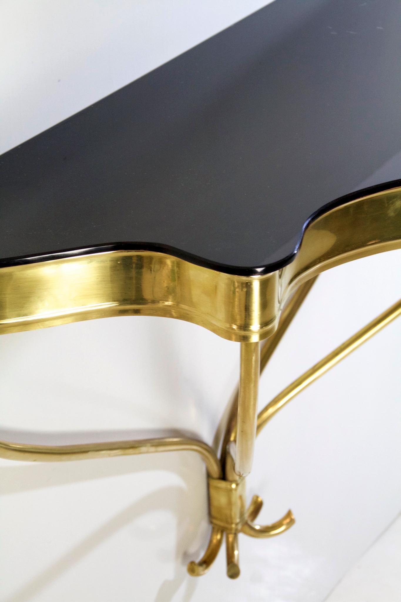 Italian console table in brass with a black glass top made in the 1950s.