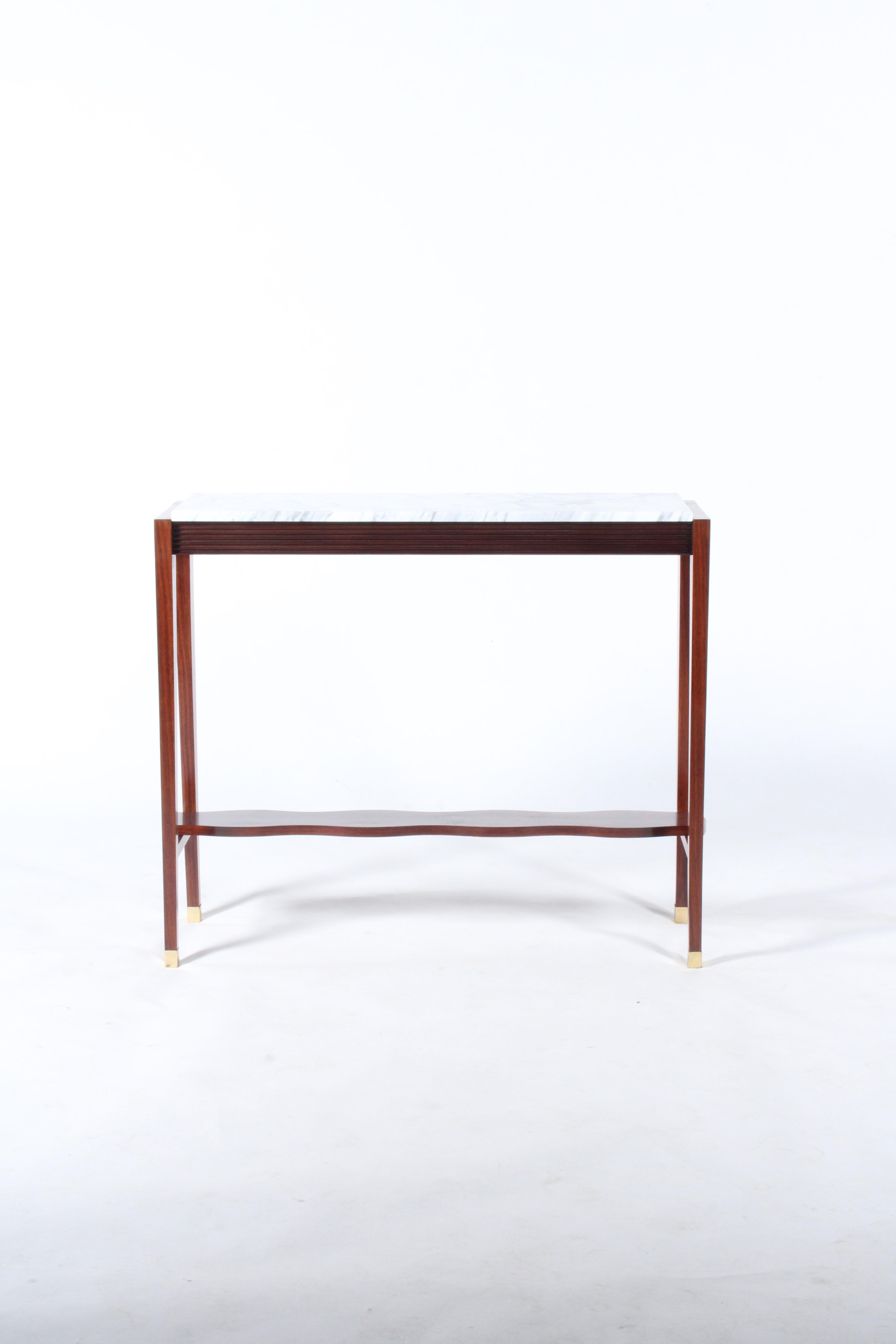 A simple yet beautiful mid century Italian console table in a gorgeous deep grained rosewood with marble top and brass detailing. A curving shelf to the base contrasts perfectly with the slick clean lines of the piece. Please see our additional