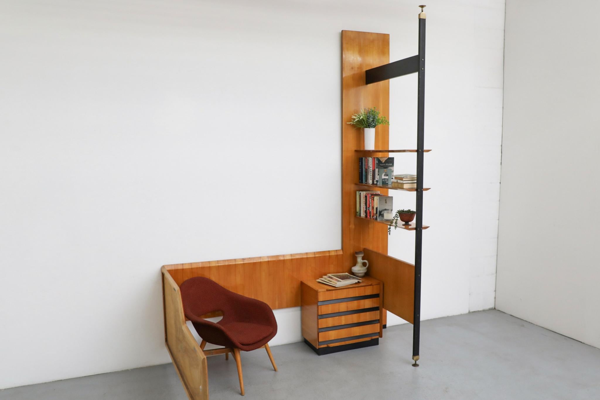An architecturally compelling Italian Mid-Century Modern corner room divider shelving unit, attributed to the elegant design sensibility of the Gio Ponti style. This piece offers a sophisticated, adaptable storage solution, featuring a