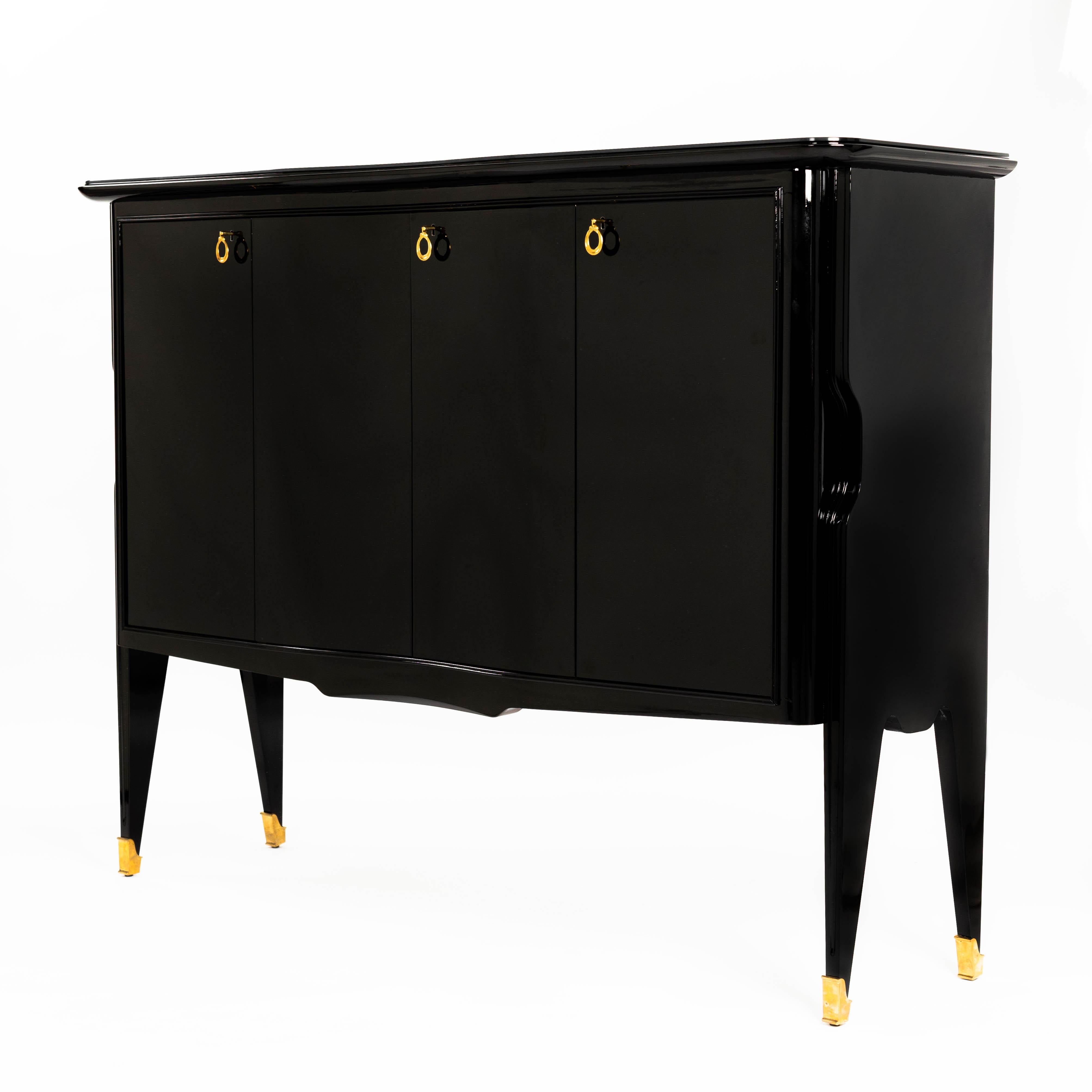 Elegant four-door sideboard - mid-century credenza, attributed to Vittorio Dassi, Italy.
(Vittorio Dassi 1893-1973)
Sycamore solid wood lacquered in high gloss black, the top of the furniture is protected with a loose laid black glass top and you