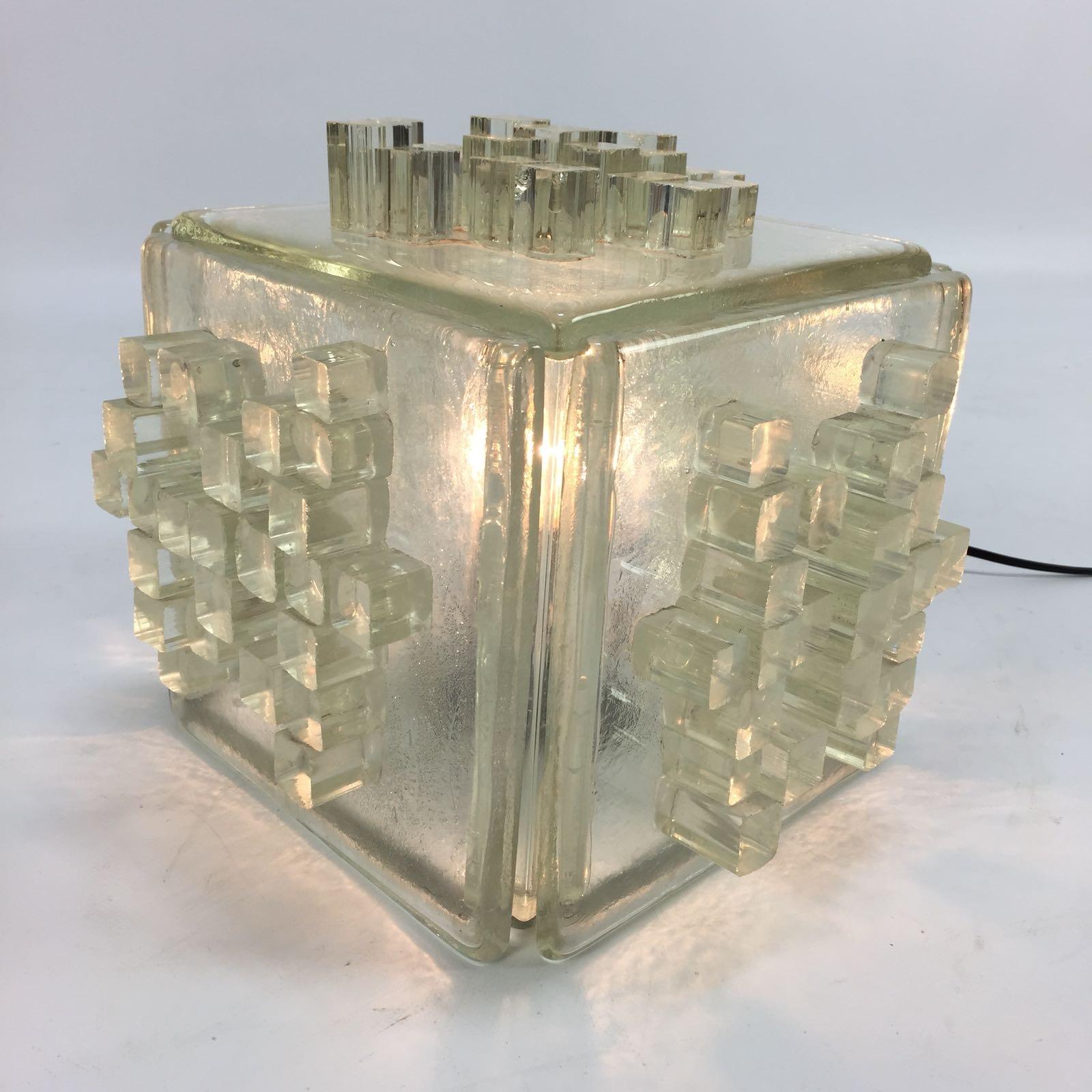 Original Poliarte ‘Apis’ lamp, made in Italy in the 60's.

This lamp is made of thick slabs of raw crystal with a graphic pattern of glass cubes on each side. 
The raw glass creates a great light effect when lit. 

Poliarte started to produce
