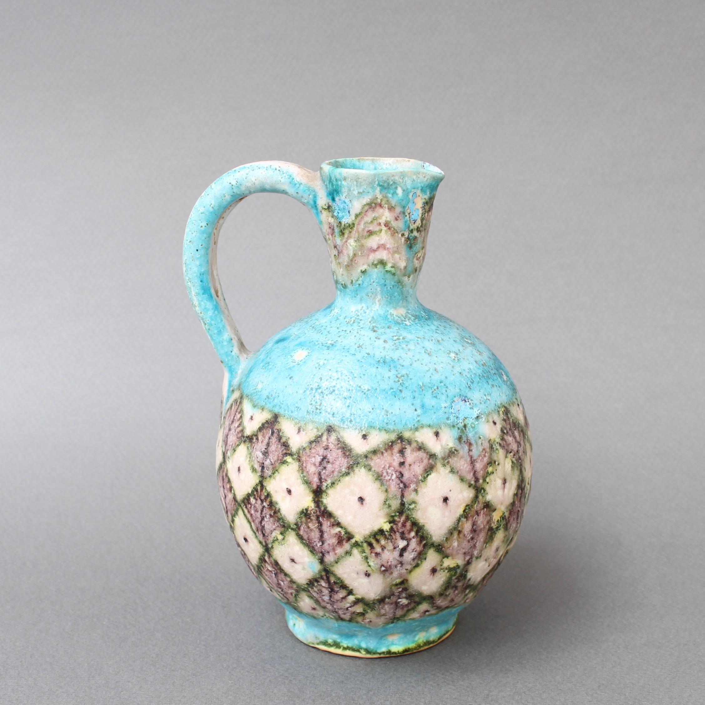 Midcentury decorative ceramic jug by Guido Gambone (circa 1950s). Truly a work of art, this piece is reminiscent of ancient amphorae from Byzantium. The once vibrant turquoise is now elegantly aged. The band encircling the piece presents geometric