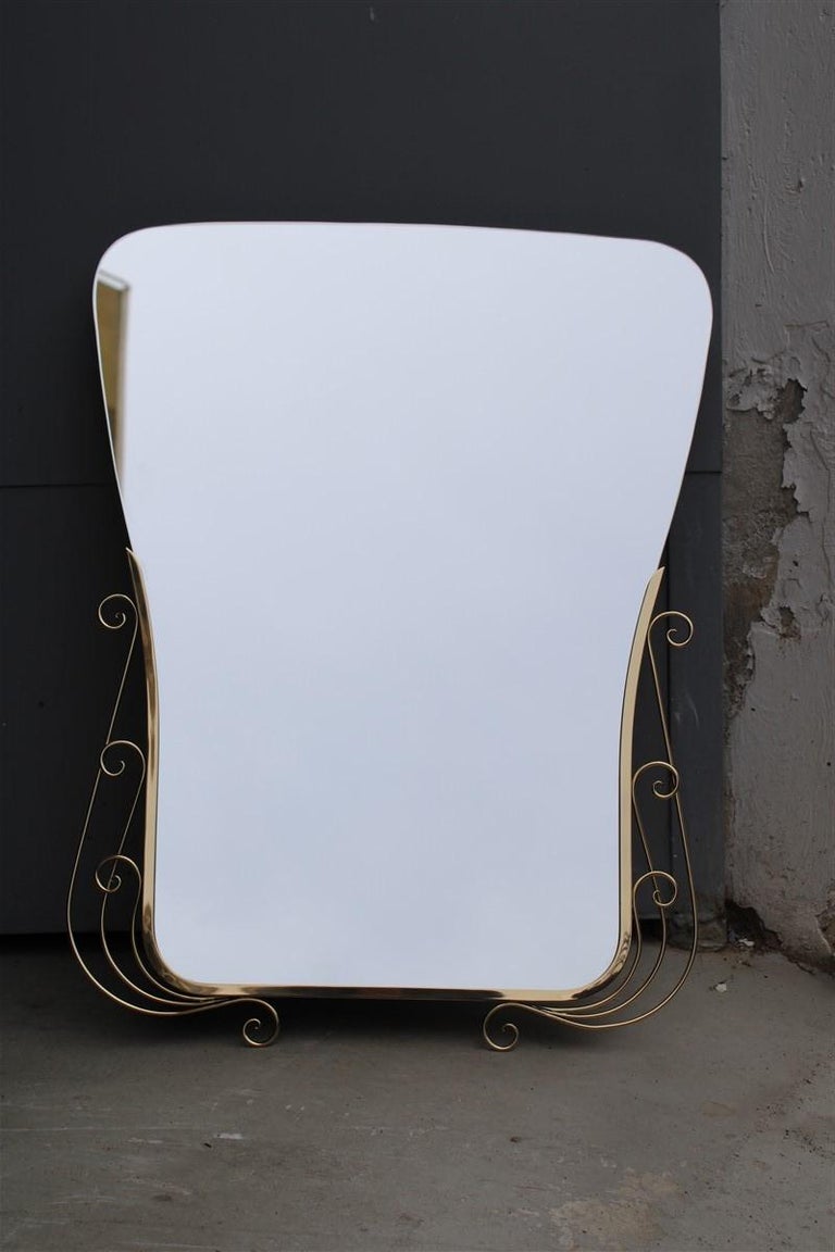 Mid-century Ialiano decorative mirror with gold brass and shaped mirror.