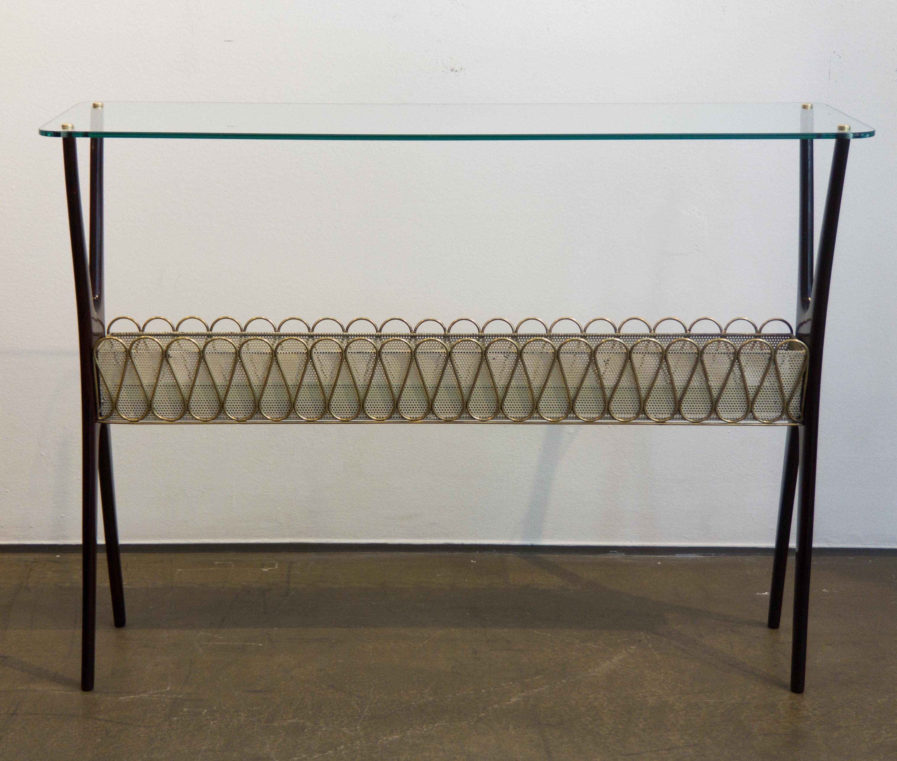 Very elegant Mid-Century console table from Italy designed by Cesare Lacca around the 1950s. The console table is made from rosewood and has a glass top which is fixed to the frame with four polished brass covers. The sideboard has two X-shaped