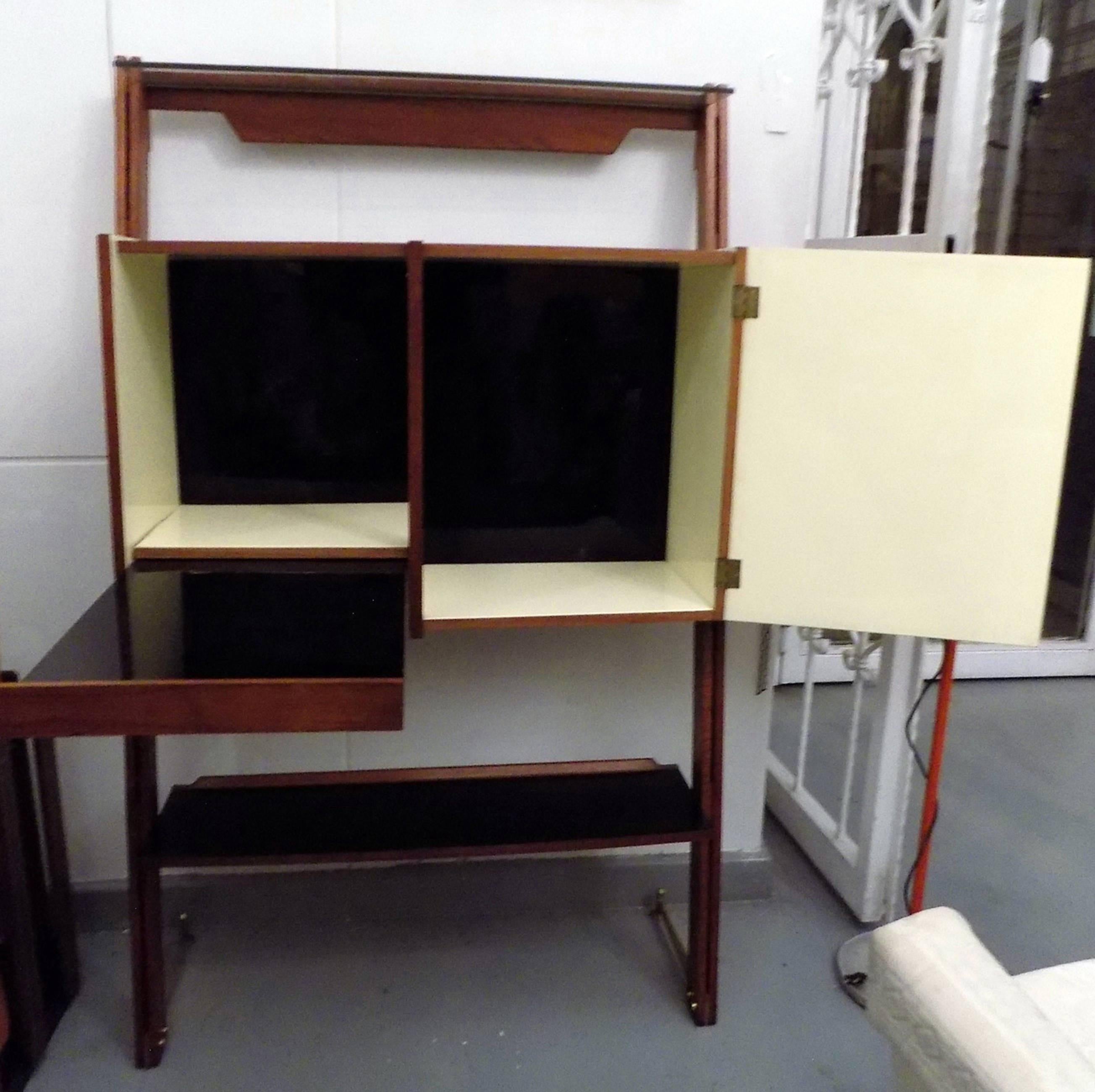 Rare drinks bar made to look like it is leaning over with original Fornasetti style bicycle printed yellow Formica panels on the front. The body of the cabinet is made in oakwood, with yellow Formica lining on the interior as well as a black Formica