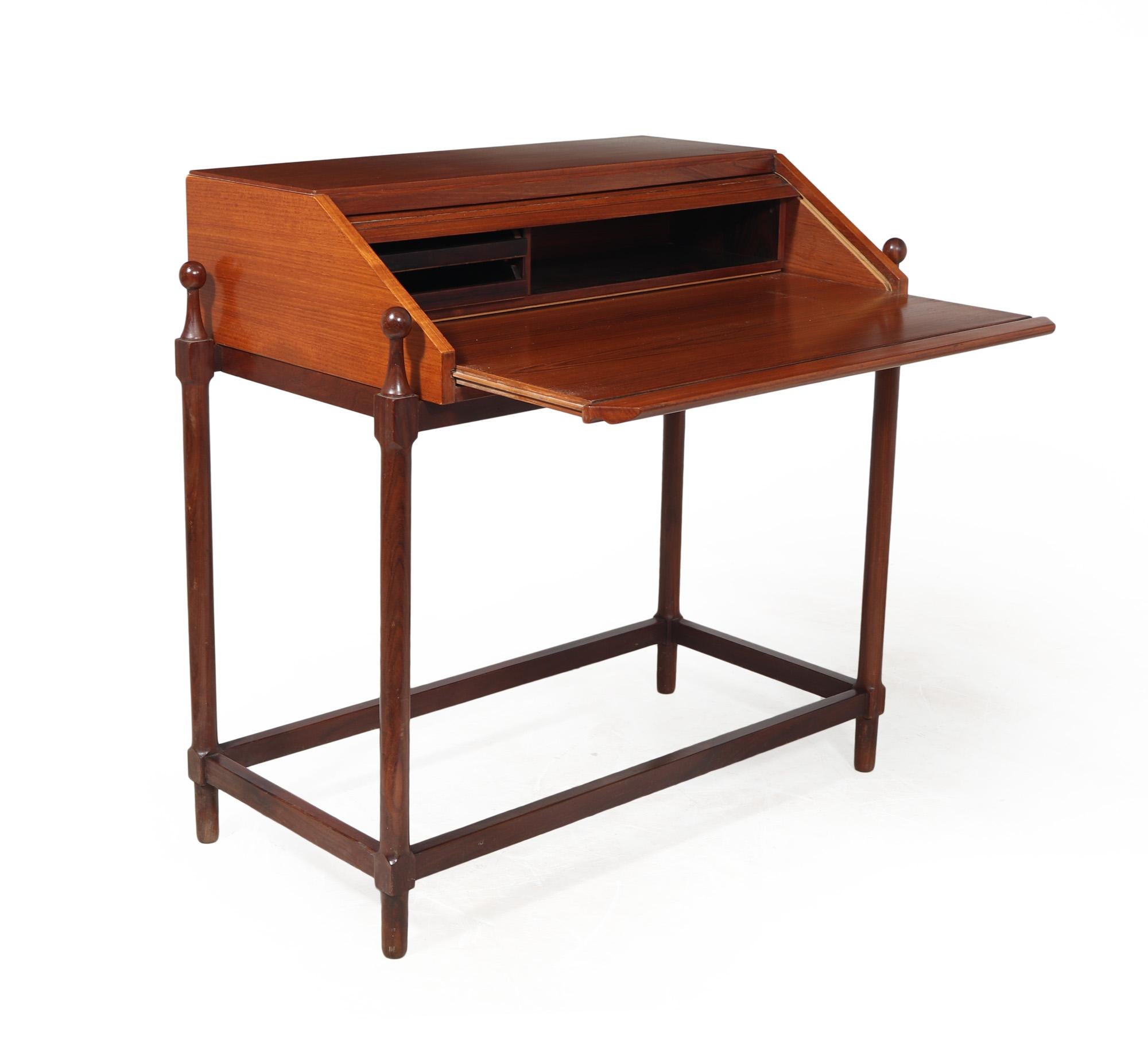 DESK BY FRATELLI PROSERPIO
This vintage Modernist writing desk produced in Italy in the 1960's by Fratelli Proserpio. It features a unique tambour slide mechanism that reveals the writing surface when pulled out. Inside, there is a small shelf for a