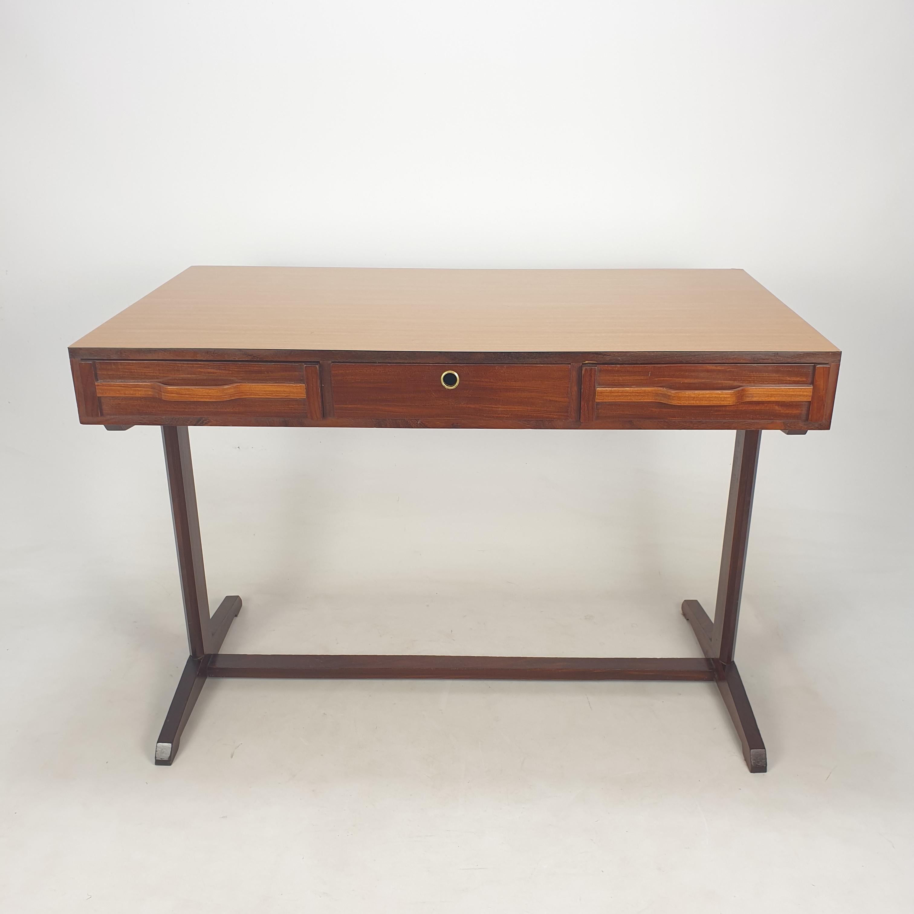 Very nice writing desk, designed by Giancarlo Frattini.
It is fabricated in Italy in the 50's.

This desk has three drawers and is in good vintage condition (see the pictures).
 