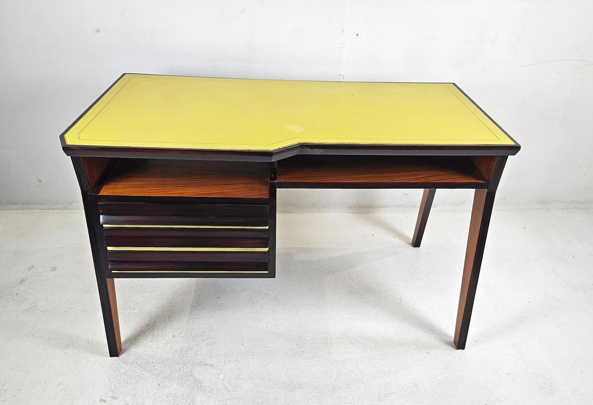 A wonderful mid century modern desk with a sleek design that functions in any modern day setting. If features an it's original canary yellow glass top as well as three drawers on the side. It is also open underneath the top which is ideal for