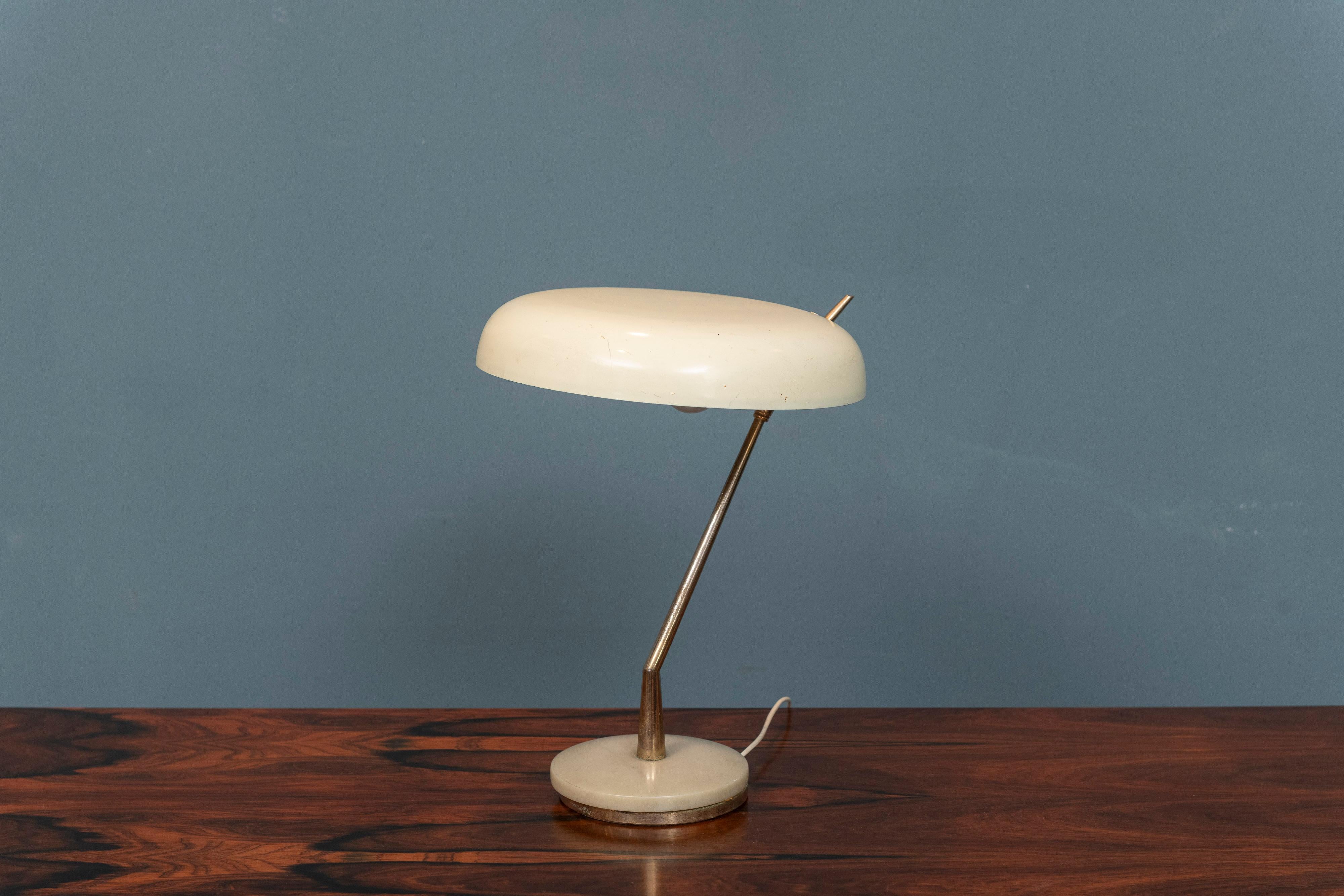 Mid-Century Italian desk or table lamp. Ivory enamel shade on an angular brass neck and marble base. Shade can be turned or directed as desired, a great desk or nightstand lamp. In very good original working condition, adaptor included for US