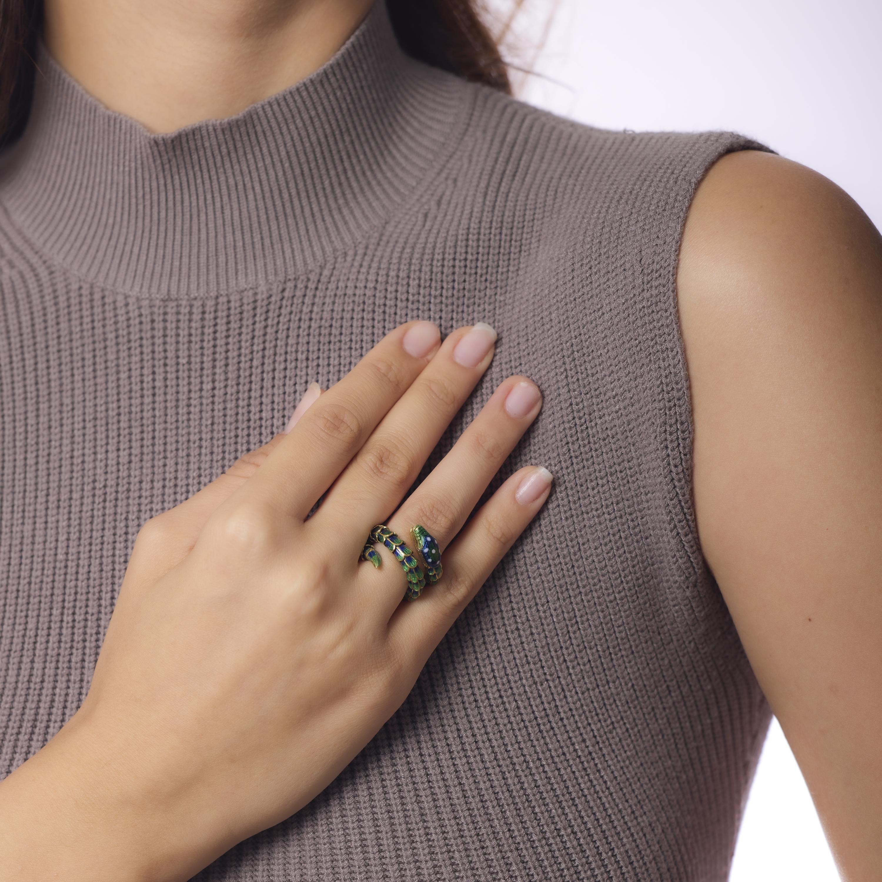 This Mid Century Italian snake ring coils in rich 18k yellow gold with deep enamel detailing and two glittering diamond eyes. Crafted in the 1950s and hallmarked Italy, its flexible form and bold styling embody vintage allure and serpentine elegance.