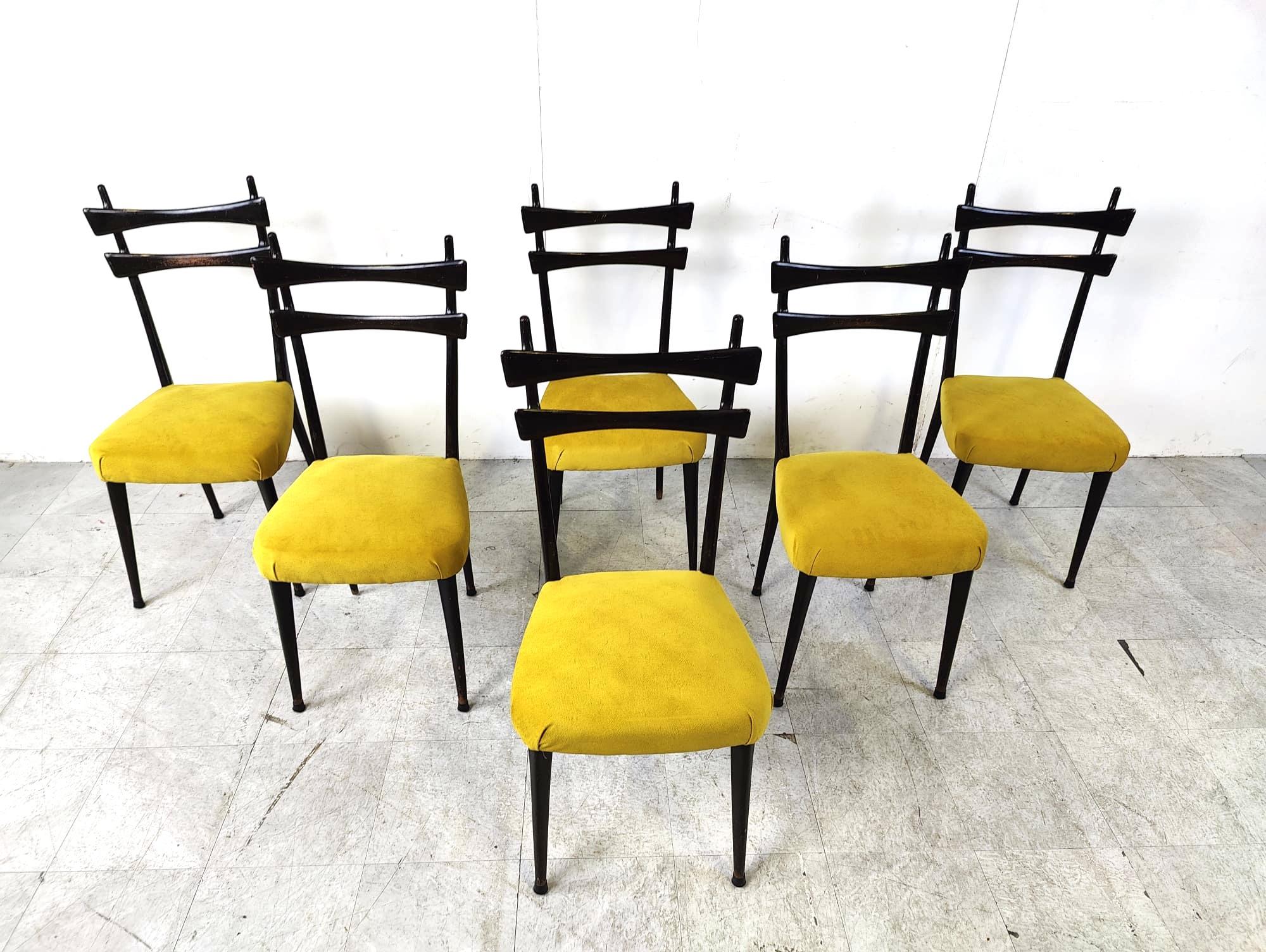 Mid century italian dining chairs made from an incredibly elegant ebonized wooden frame and reupholstered in oker/yellow fabric.

Beautiful italian design from the 1950s very much in the style of Gio Ponti.

They are very light but very sturdy and