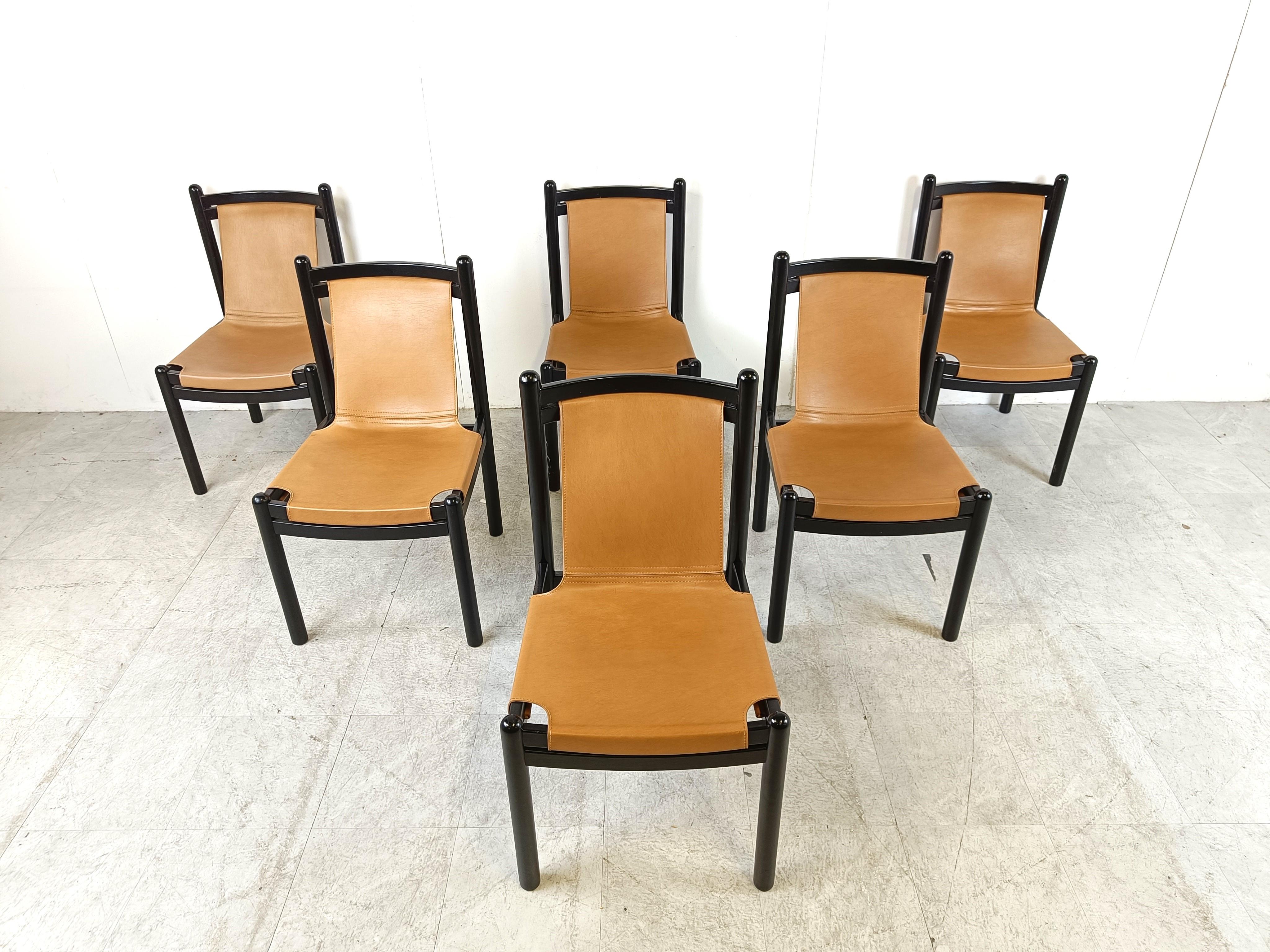 Mid century lacquered wooden dining chairs with camel brown sling leather seats.

Very elegant mid century chairs.

1960s - Italy

Dimensions:
Height: 88cm/33.46