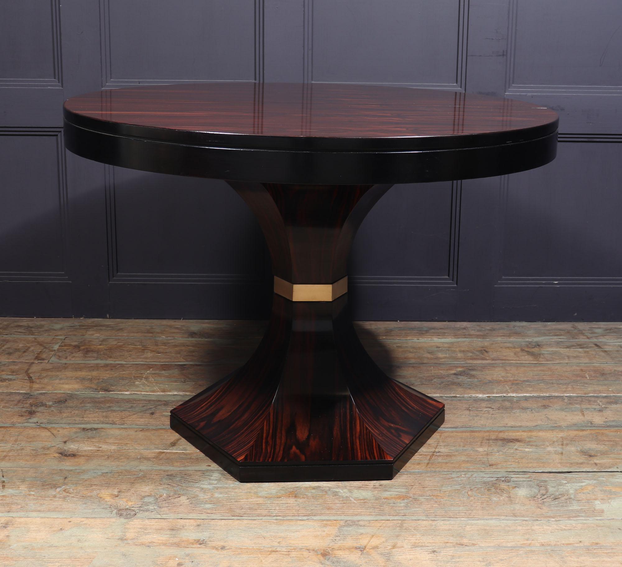 DINING TABLE BY CARLO DE CARLI
An extremely rare Macassar ebony extending table by Italian designer Carlo de Carli, extending top to accommodate a single butterfly leaf that stores inside the top, this sits on a hexagonal trumpet base with brass