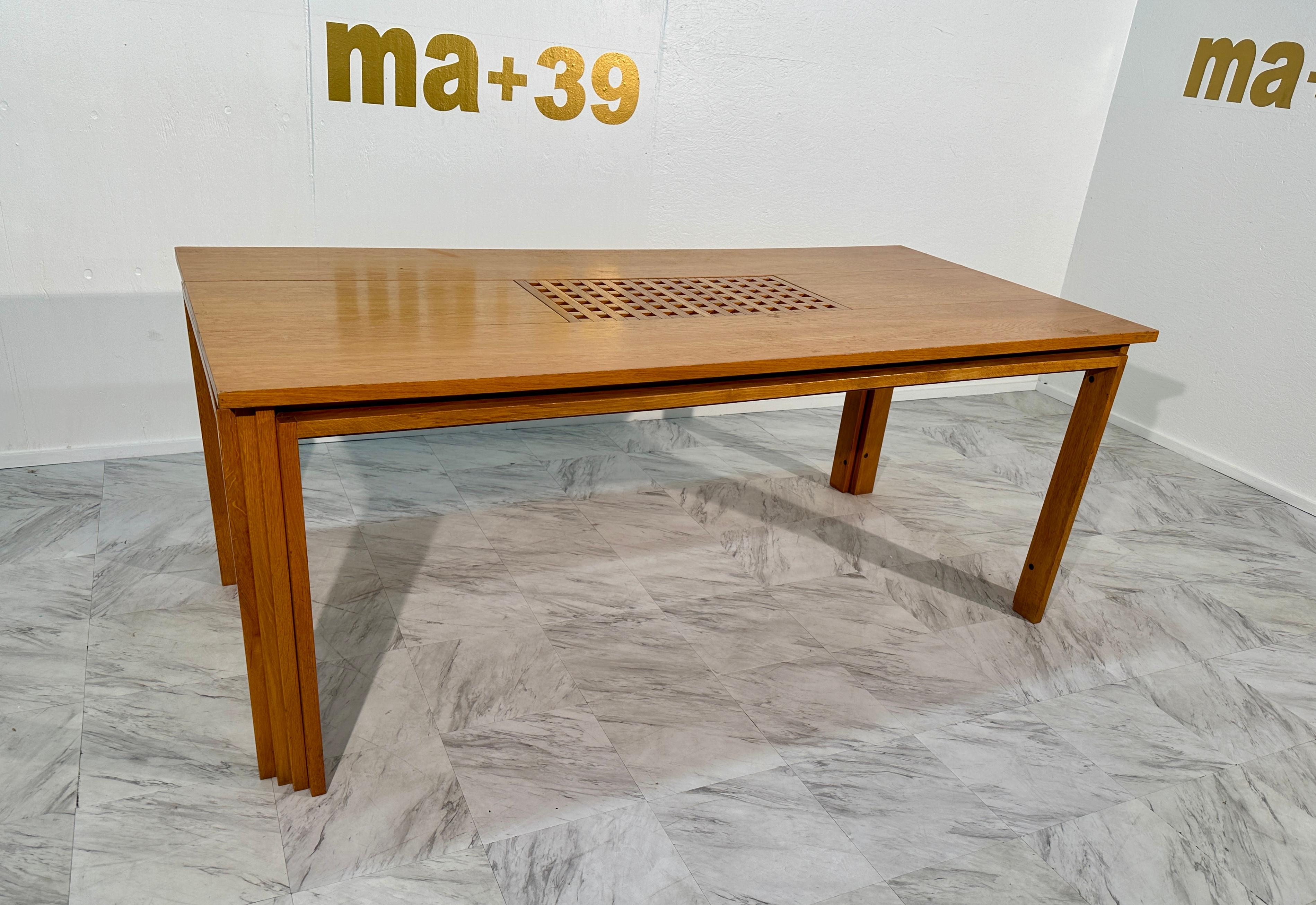 The Mid Century Italian Dining Table by Pozzi & Verga, crafted in the 1960s, is a masterpiece of mid-century design. Exhibiting a timeless elegance, this rectangular dining table boasts a fully wooden construction, showcasing the natural beauty of
