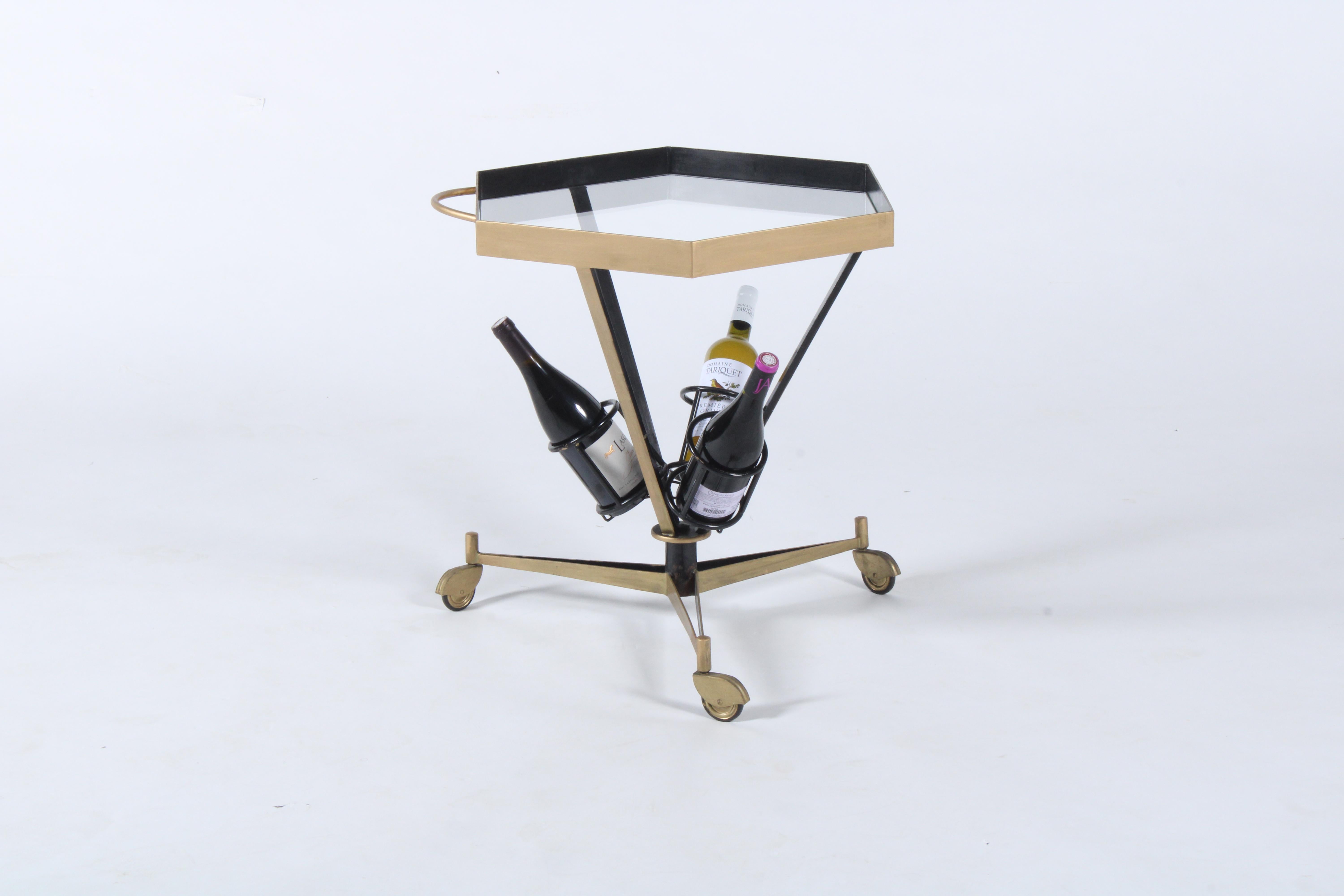 A classic mid century Italian drinks trolley in metal with a tripod base and hexagonal top. This stylish piece has been professionally restored and as such is presented in superb vintage fashion. With three bottle holders to the central column it