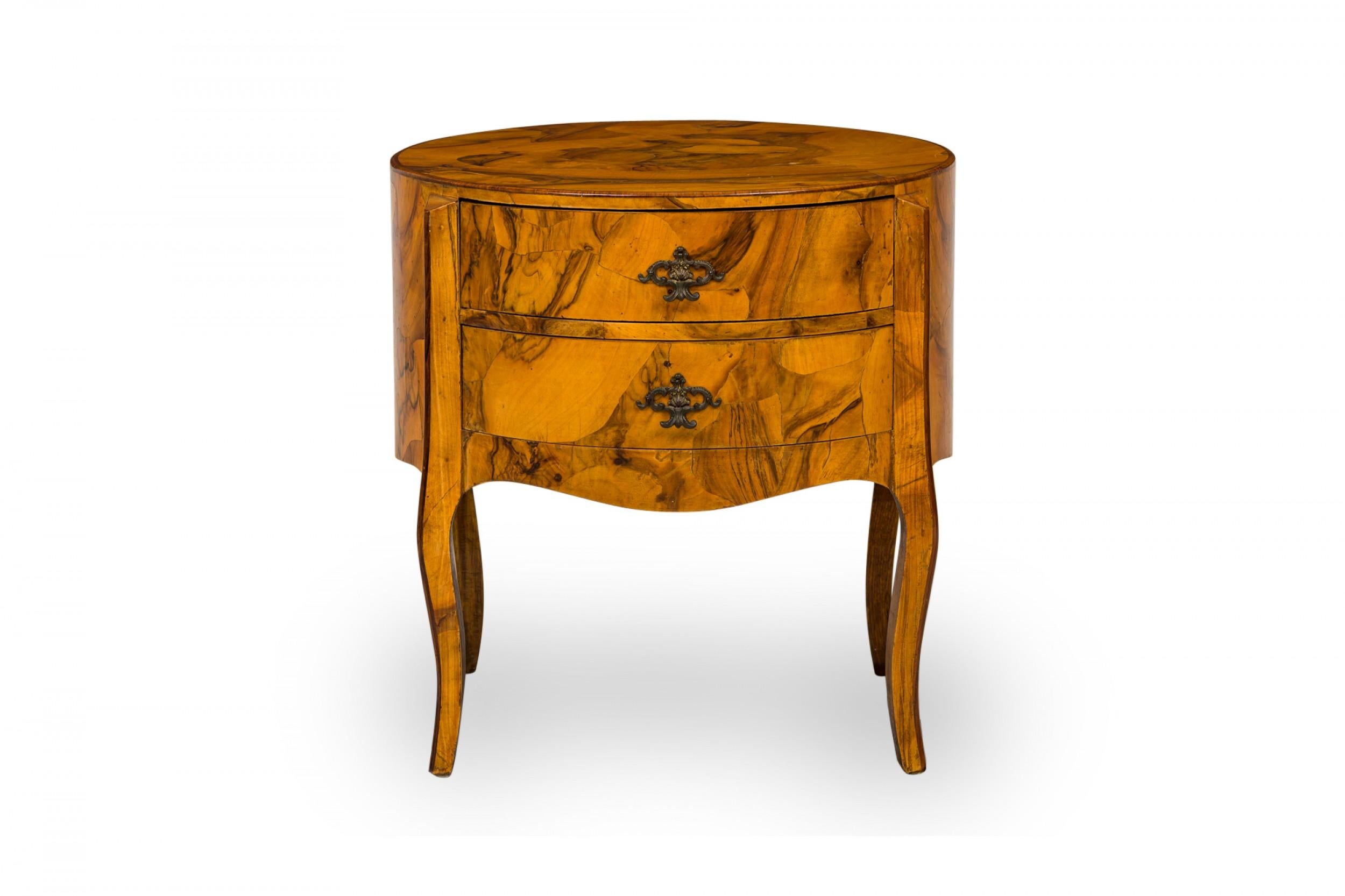 Italian Mid-Century drum form end / side table with oyster burl veneer and two drawers with shaped bronze drawer pulls, resting on four curved legs.
 