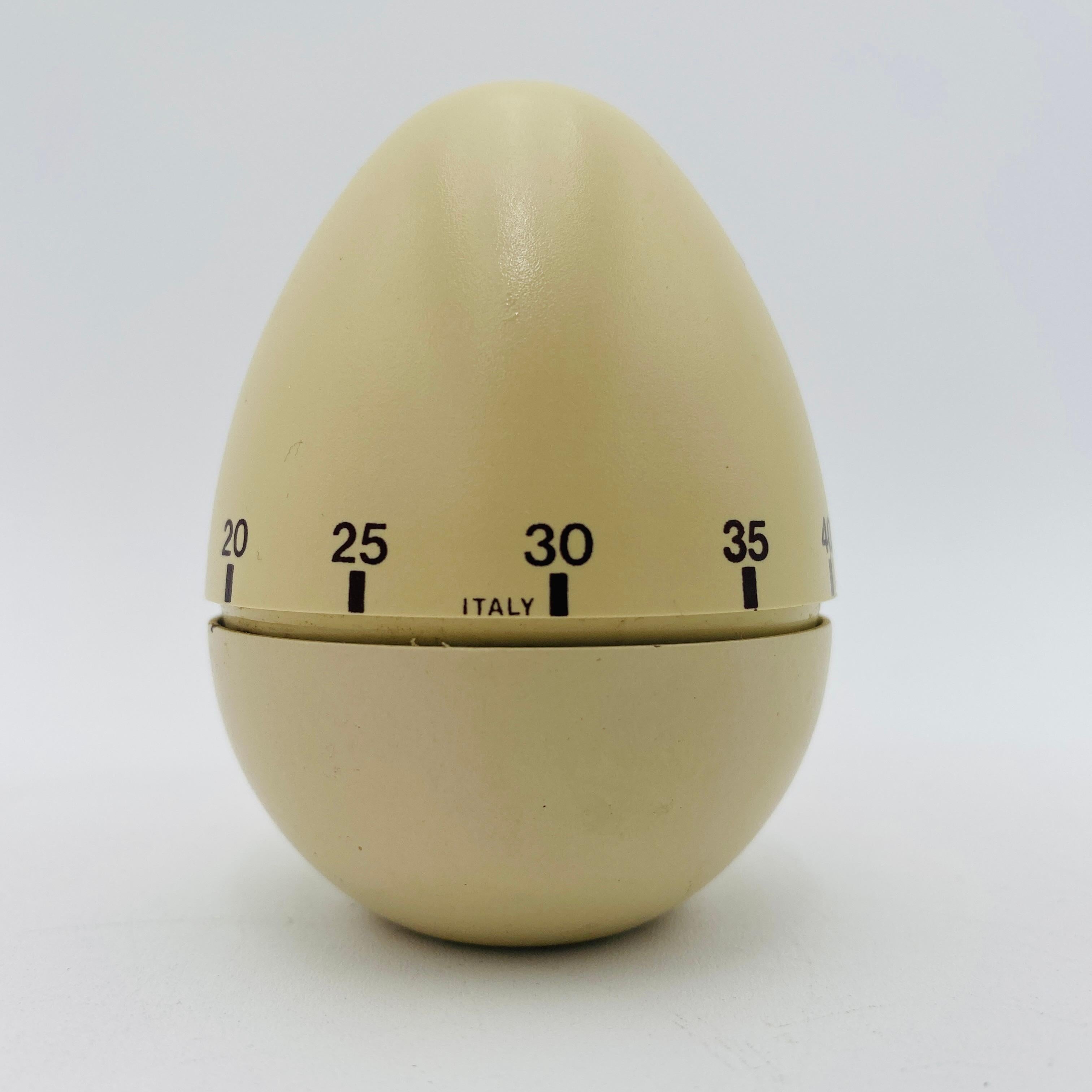 This is a mid-century mechanical egg timer, made in Italy circa the 1960s. It's a simple classic design, turn the top to set the time, and it counts down, with an alarm when done. The egg-shaped piece is a fun, decorative, and functional addition to