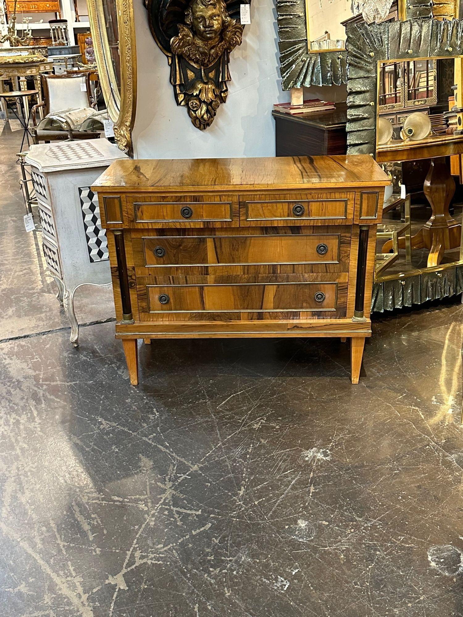 Handsome mid-century Italian Empire Style walnut chest. Featuring a gorgeous finish, lovely brass hardware and ebonized details. Makes an elegant statement!.