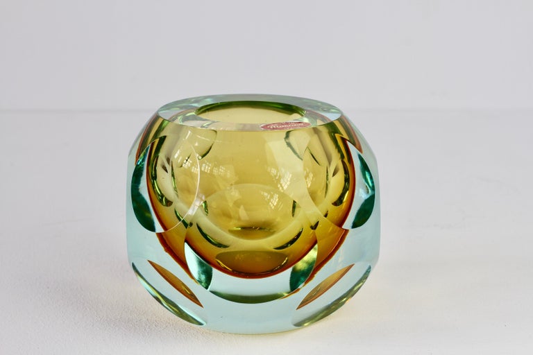 Stunning round colorful (colorful) mouth blown Murano art glass bowl or vase attributed to Flavio Poli for Seguso, circa 1950-1965. Absolutely exceptional in every way utilizing the Sommerso technique and faceted circular patches on all multiple