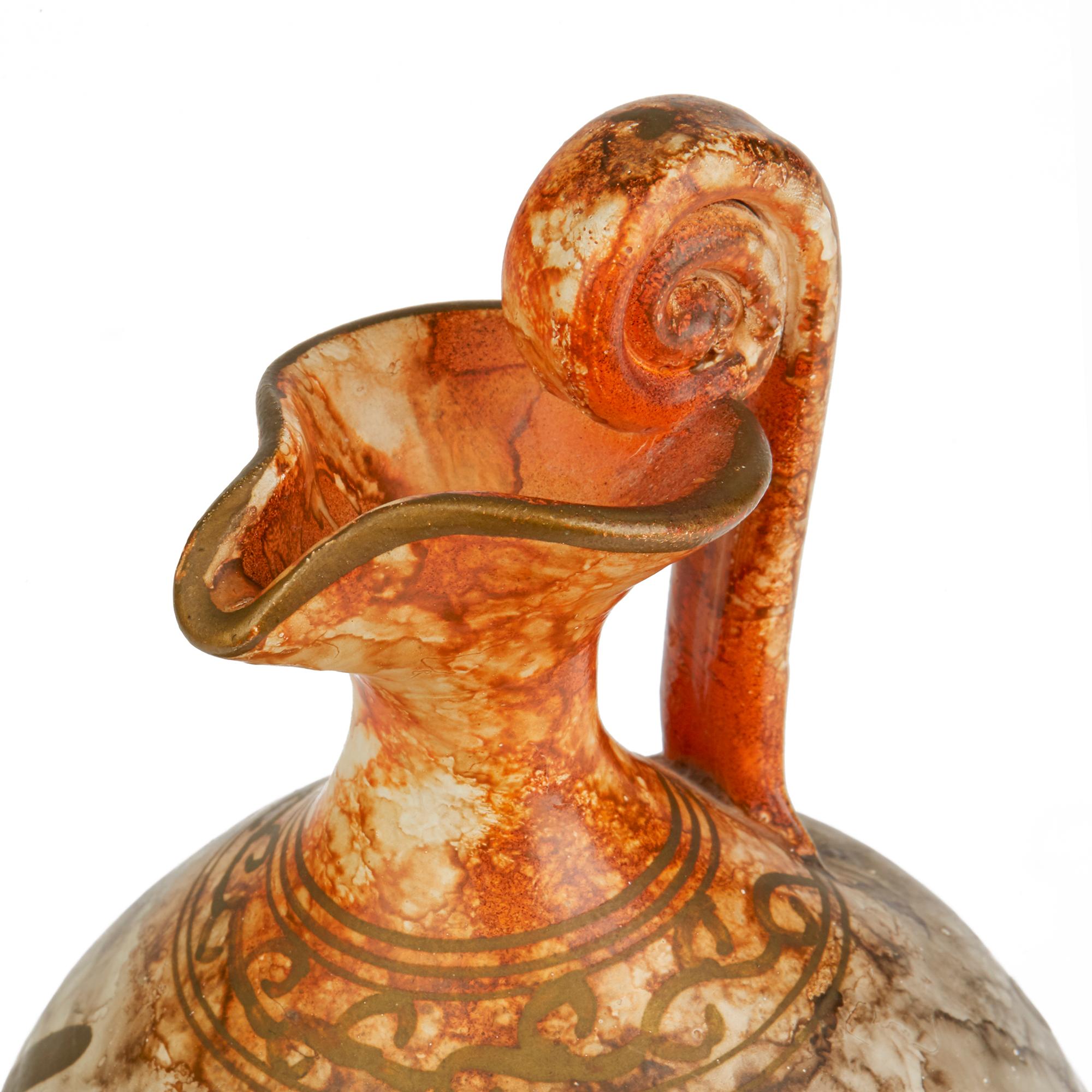 A stylish vintage Italian art pottery jug decorated with a classical figure playing a Lyre harp and attributed to Fantoni. The elegantly shaped jug stands on a narrow rounded foot with an oval shaped bulbous body short slender neck and shaped