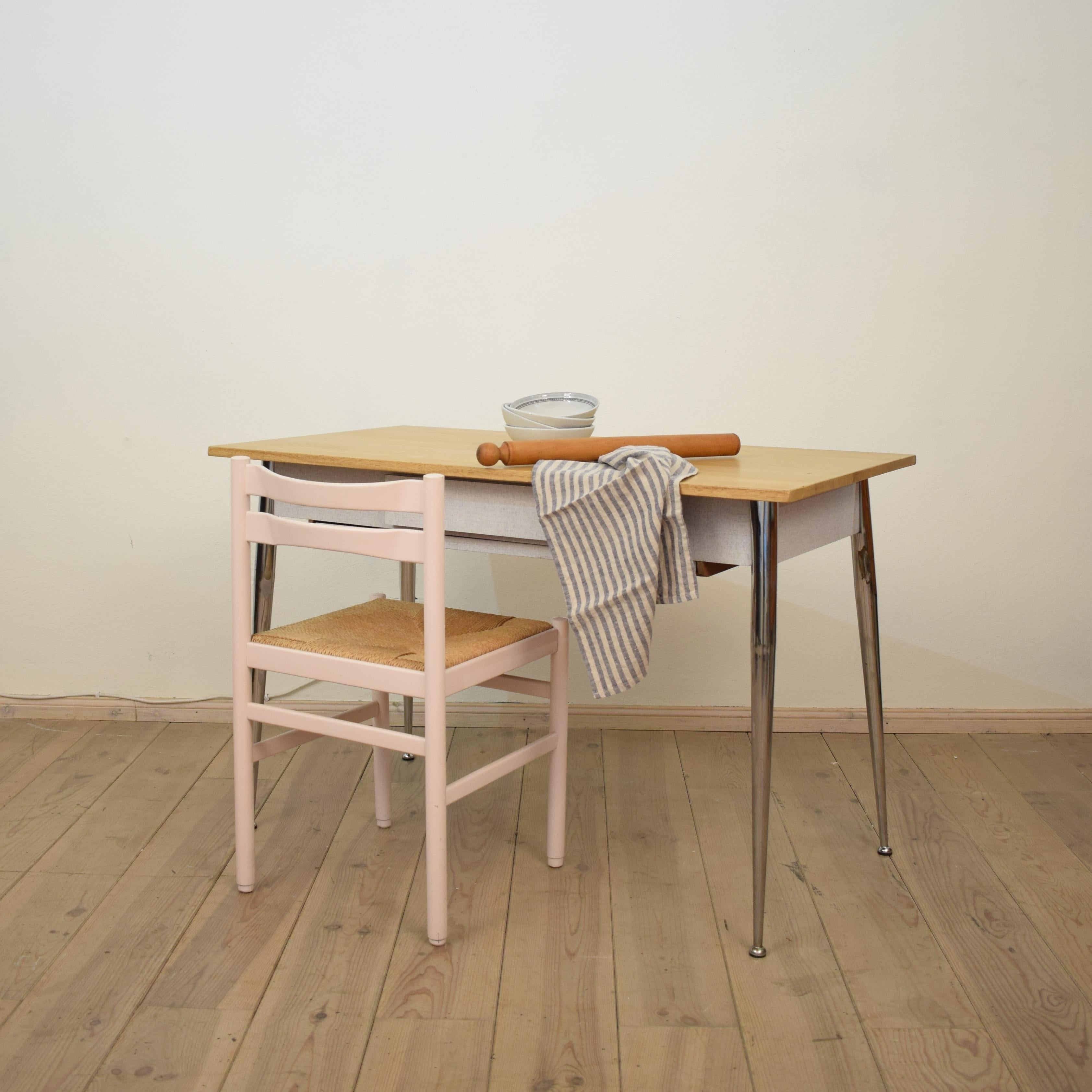 This authentic and beautiful midcentury Italian kitchen dining table was made in the 1950s. 
It is a very nice original condition with great patina. 
The later top is made out of solid wood and the rest also the drawer is veneered with Formica. It