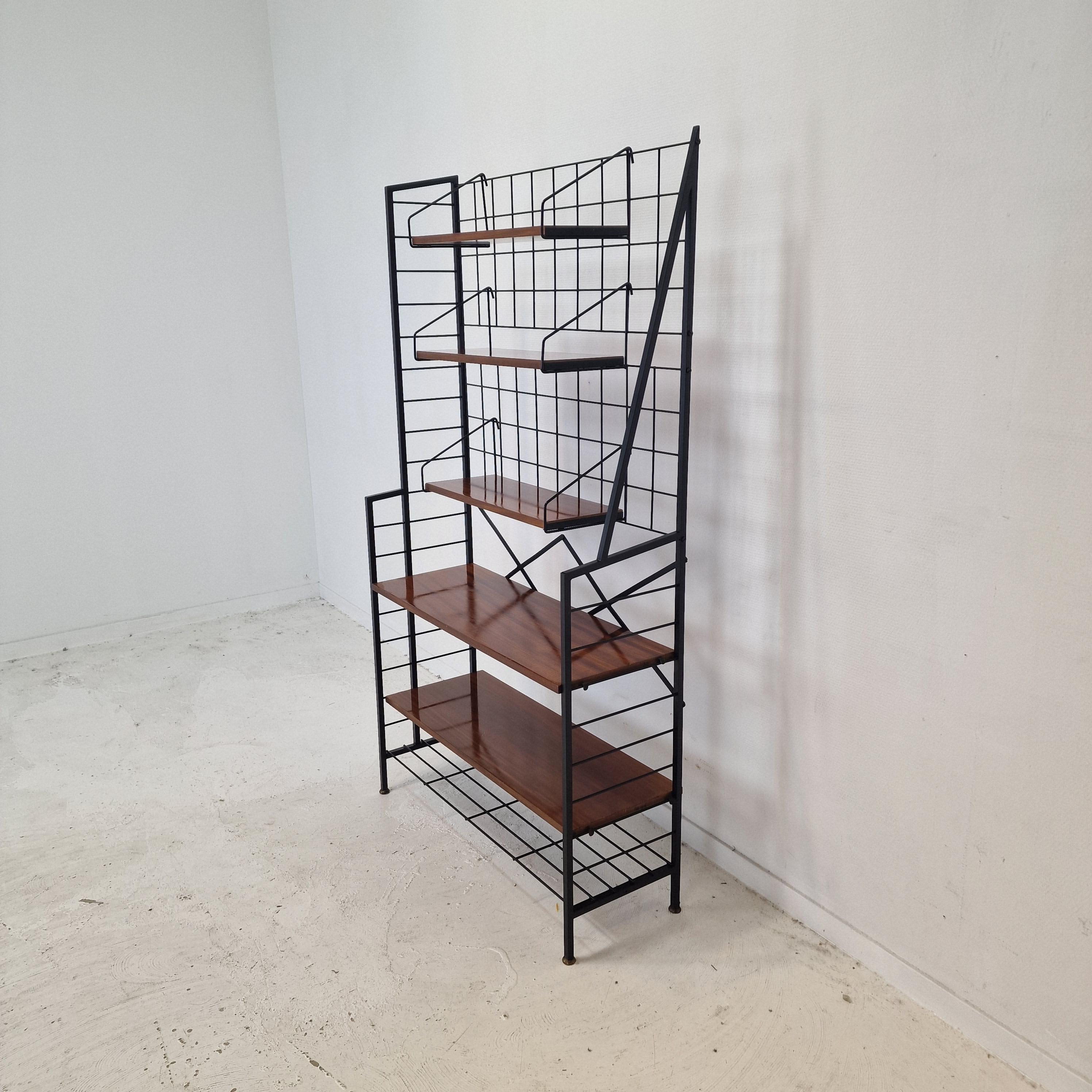 Very nice free standing shelve system, fabricated in Italy in the 50's.

Wooden (teak veneer) shelves with a black painted metal system.

It is very easy to disassemble.

We work with professional packers and shippers, we can deliver worldwide in 5