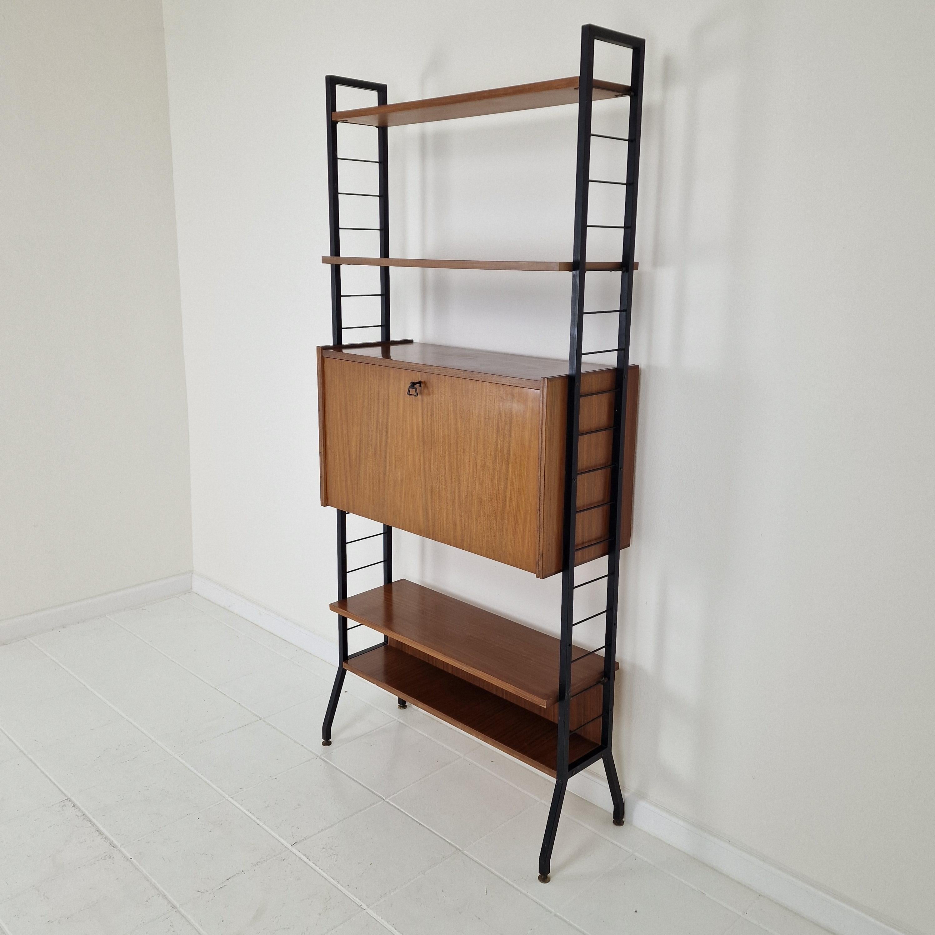 Very nice free standing shelve system, fabricated in Italy in the 50's.

Wooden (teak veneer) shelves with a black painted metal system.
One cabinet with 