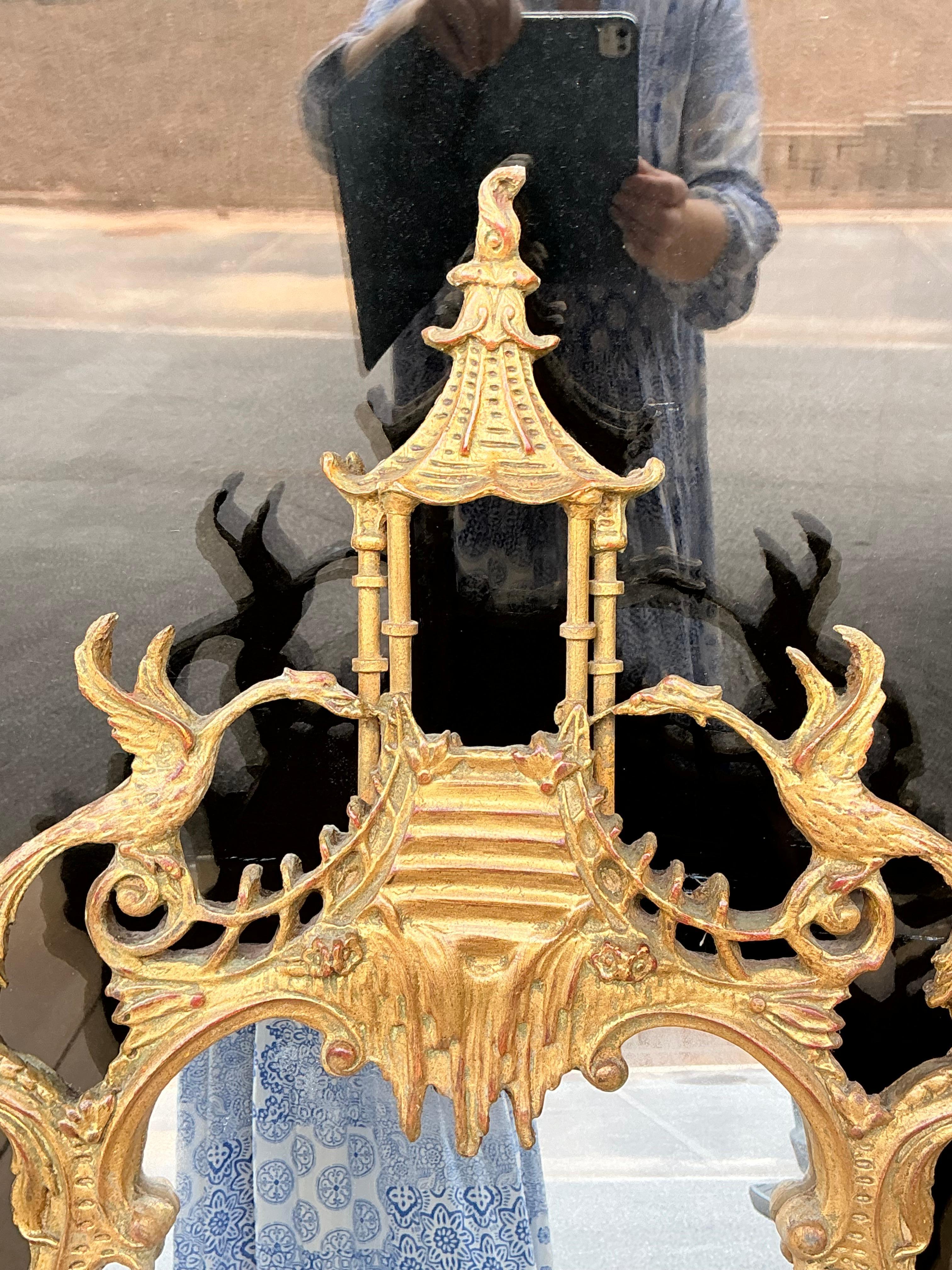 Timeless elegance! This is a mid-century carved giltwood chippendale style mirror attributed to Friedman Brothers. It has a pagoda pediment flanked by two Ho Ho birds. It is unmarked and in very good condition.

My shipping is running two to five